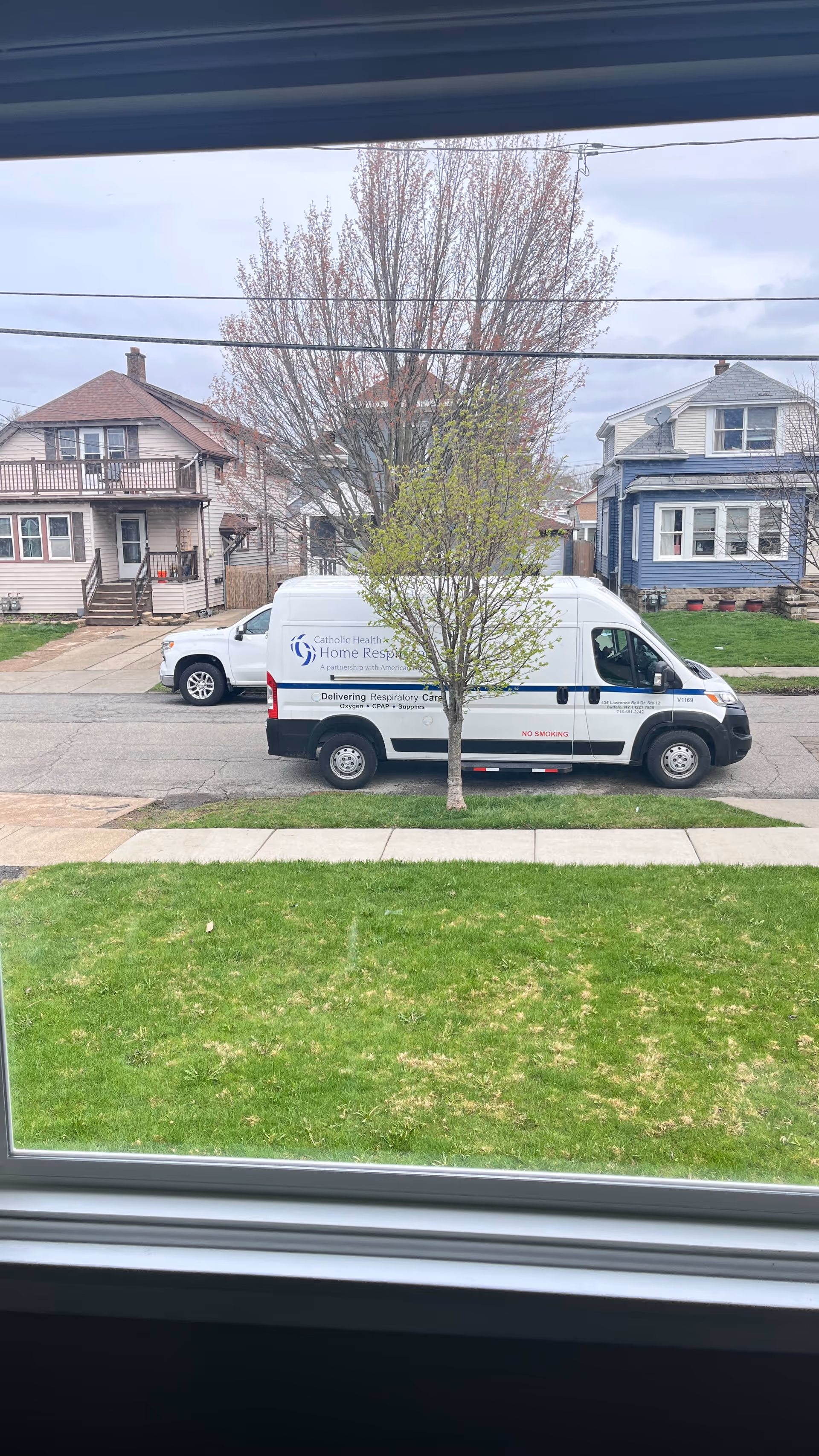 White Lincare van with Home Health branding parked on a residential street.