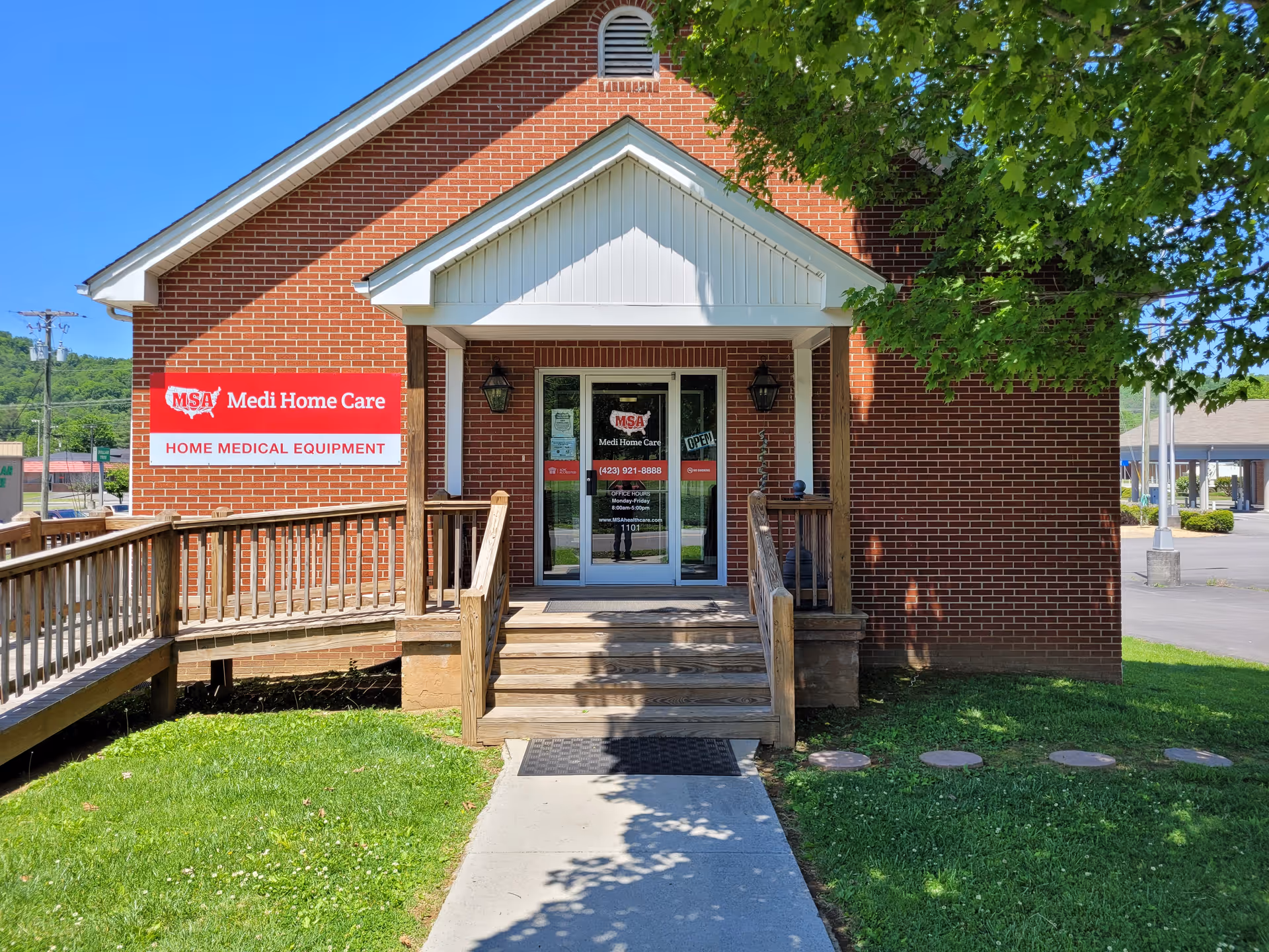 Brick building with a wooden ramp, front entrance, and Medi Home Care sign.