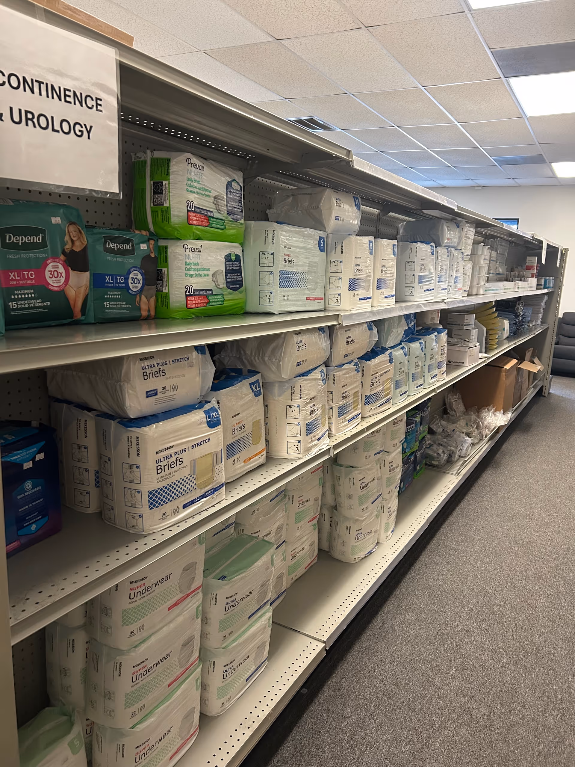 Aisle of stocked shelves with incontinence underwear and briefs in a facility supply room