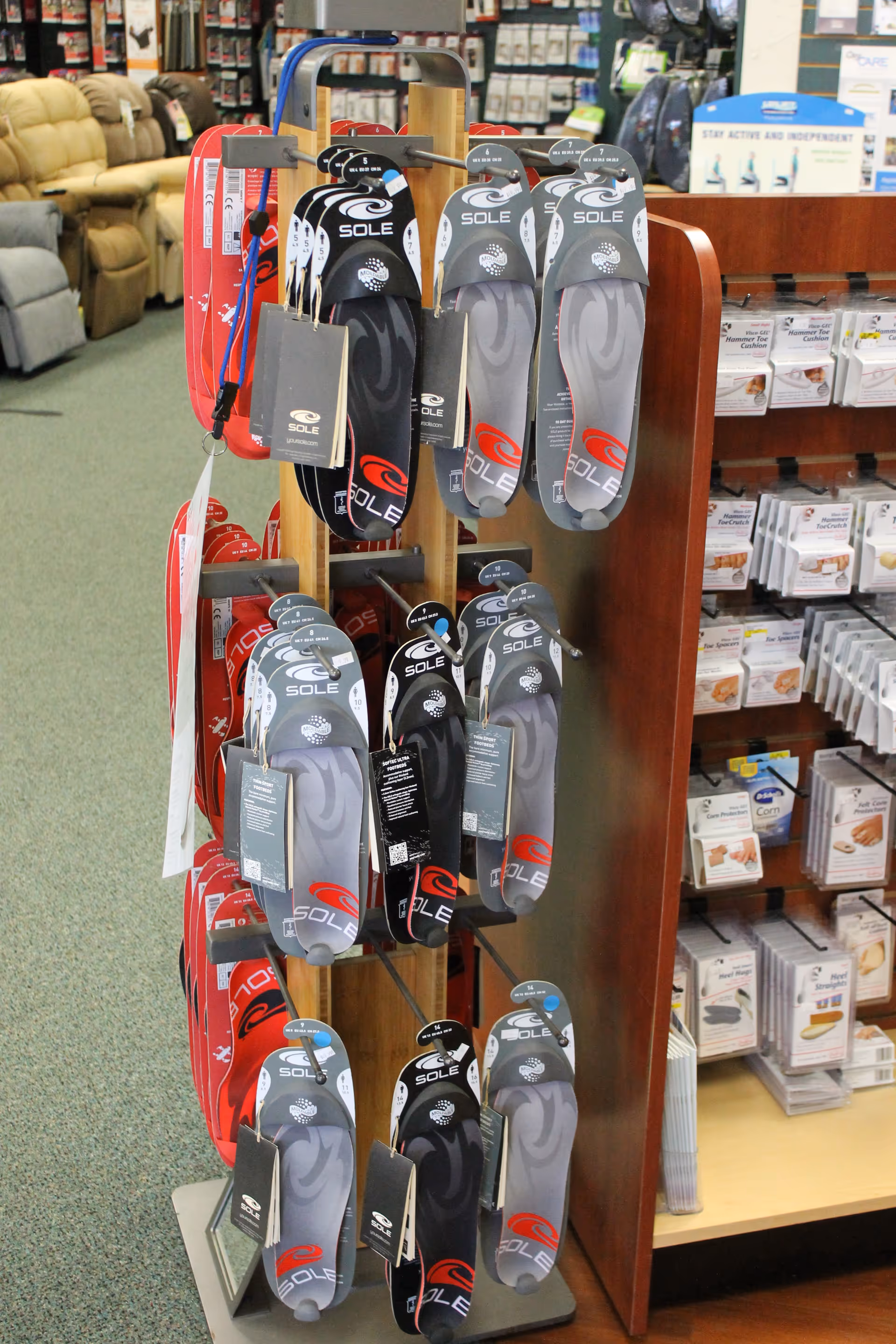 Shoe display rack featuring Sole sandals in a medical supply shop.