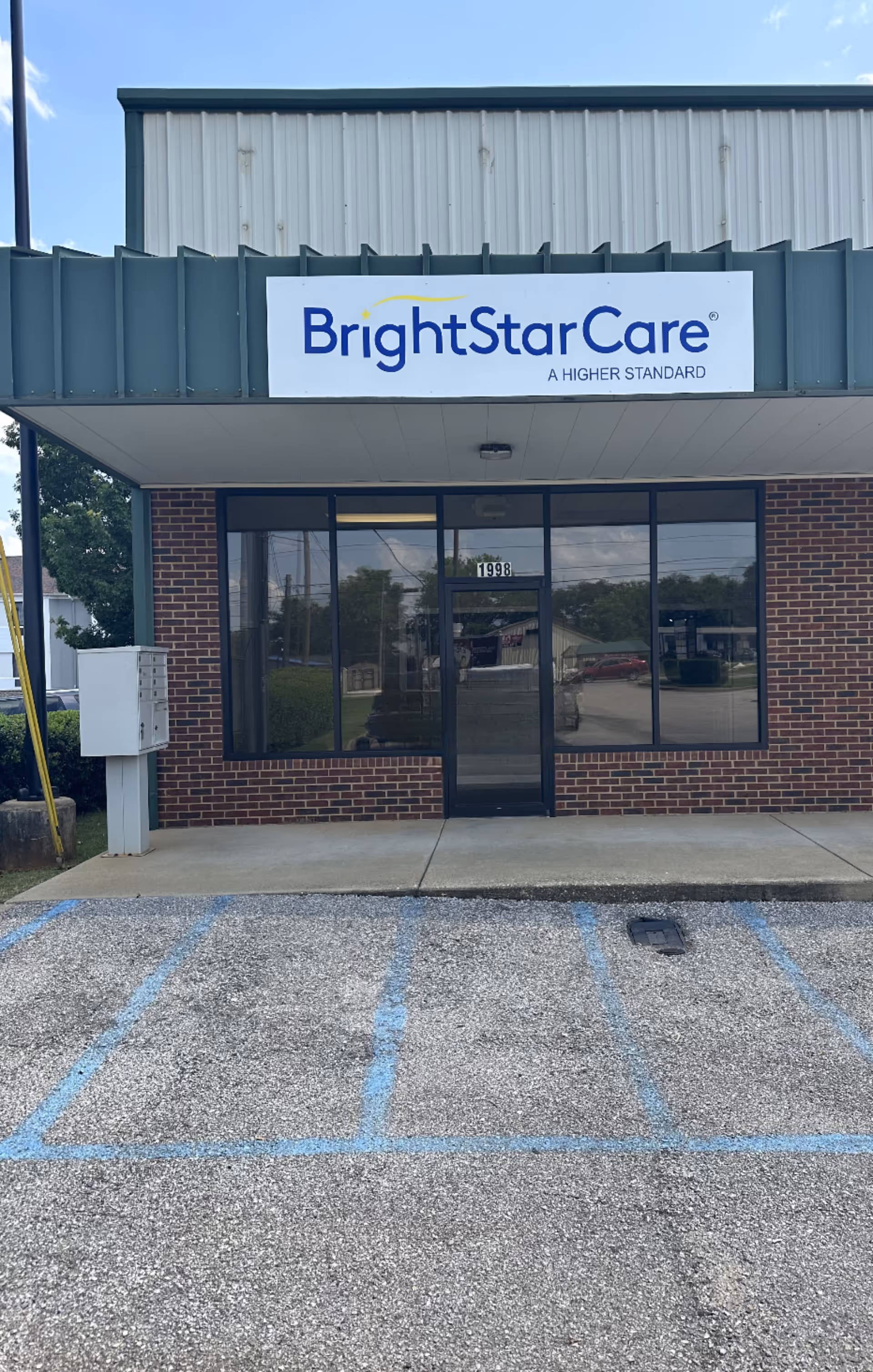 BrightStarCare storefront signage on brick building viewed from the parking lot.