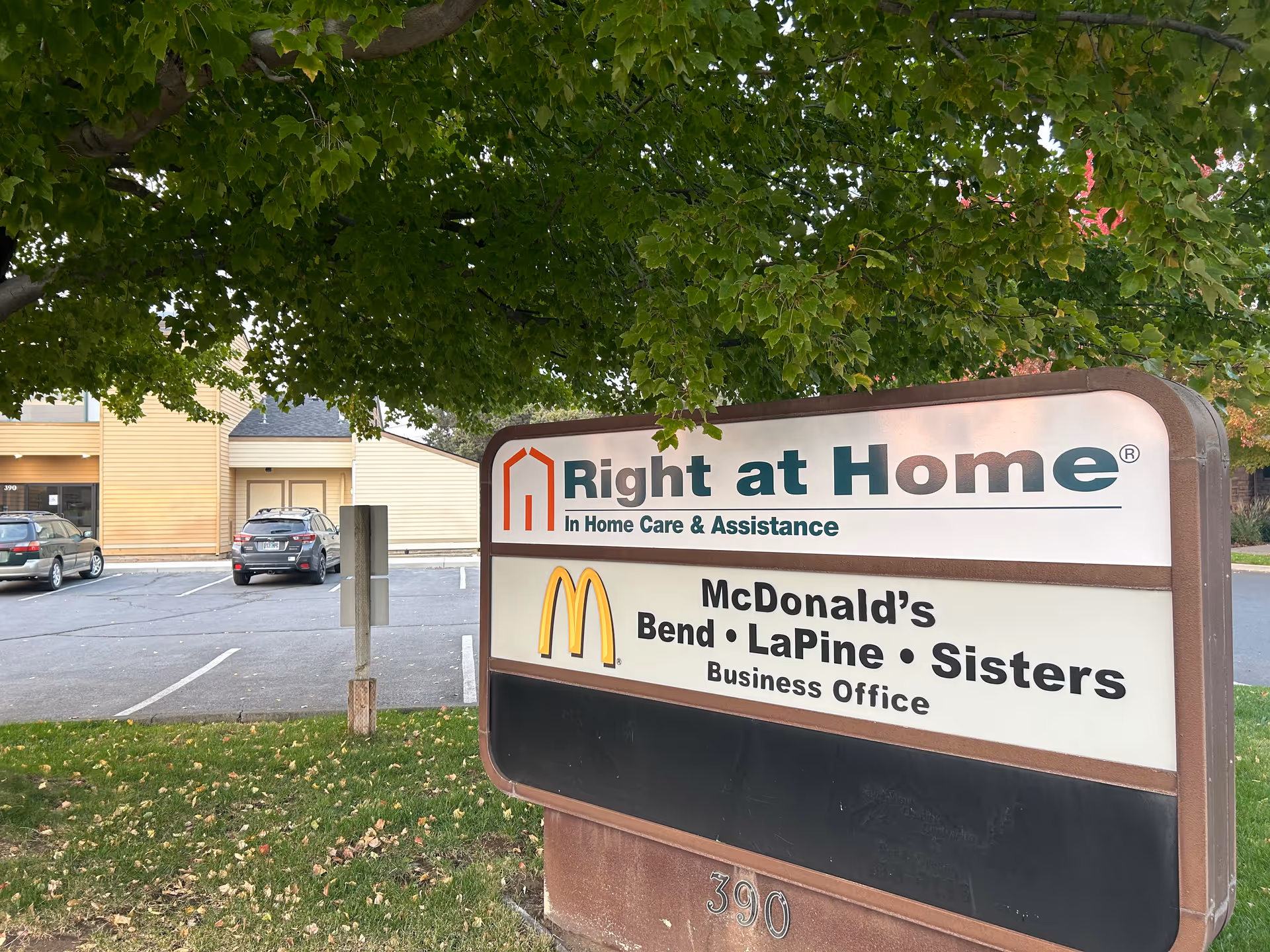 Outdoor sign for Right at Home next to McDonald's business office and parking lot