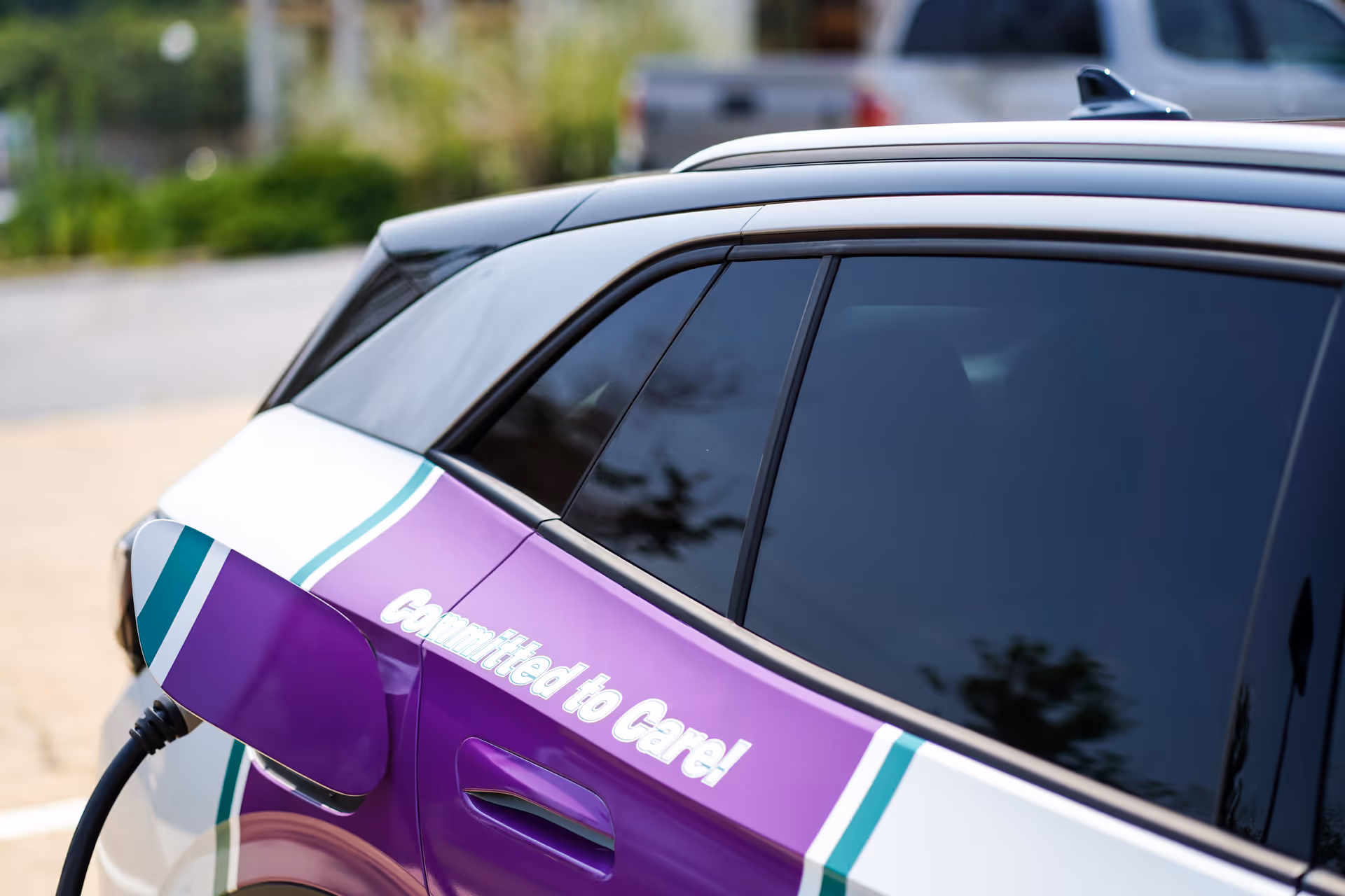 Brand-branded elder care vehicle parked outdoors with a blurred background.