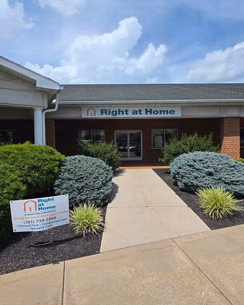 Exterior view of Right at Home senior living facility entrance with landscaping.