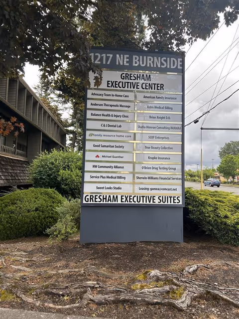 A tall exterior signboard lists tenants, including Family Resource Home Care, at the Gresham Executive Center.