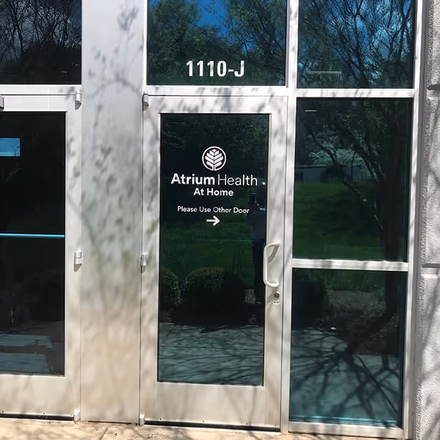 Atrium Health At Home glass entrance doors with 1110-J and a Use Other Door sign