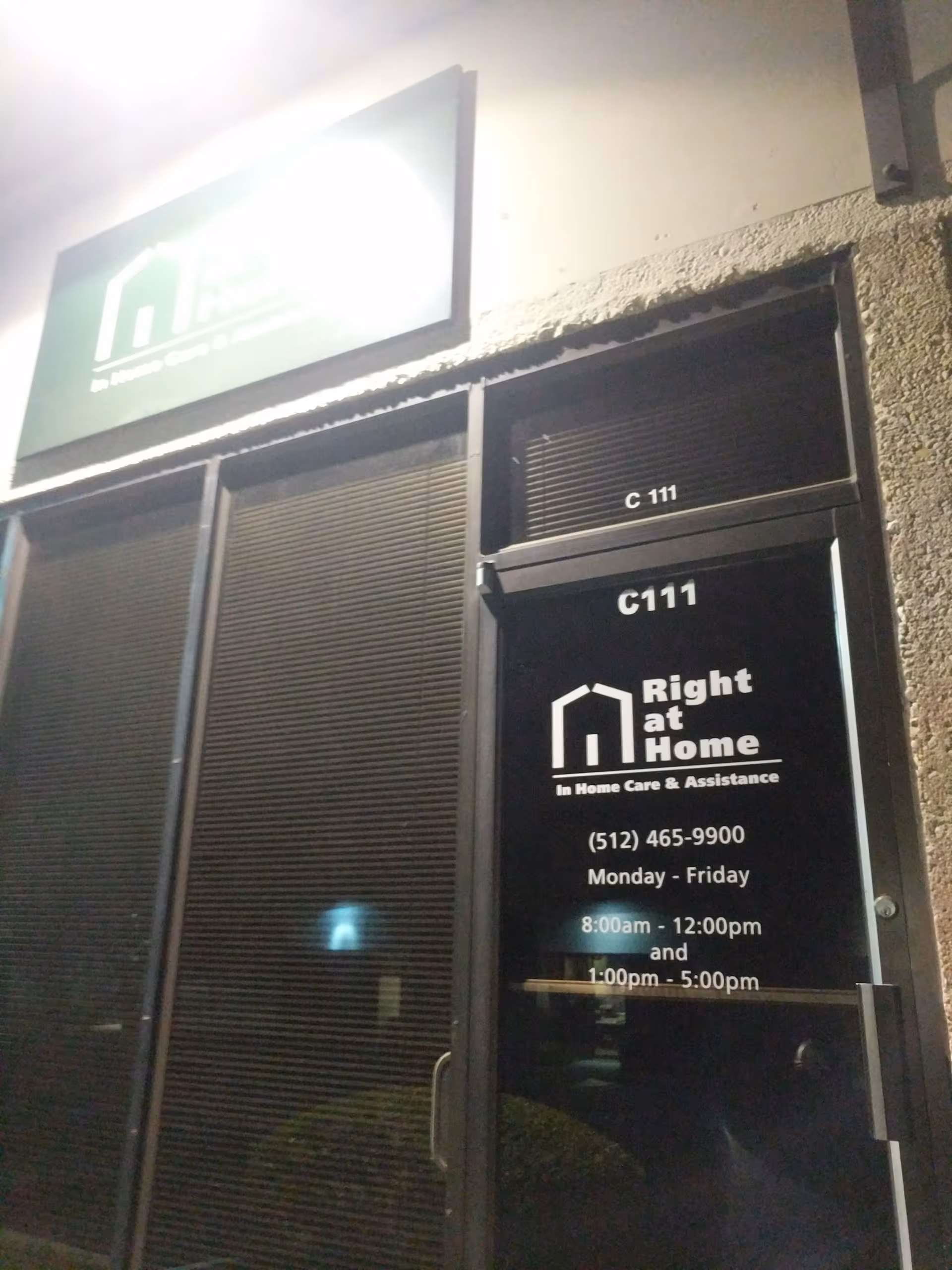 Night exterior of Right at Home entrance with logo sign and C111 door