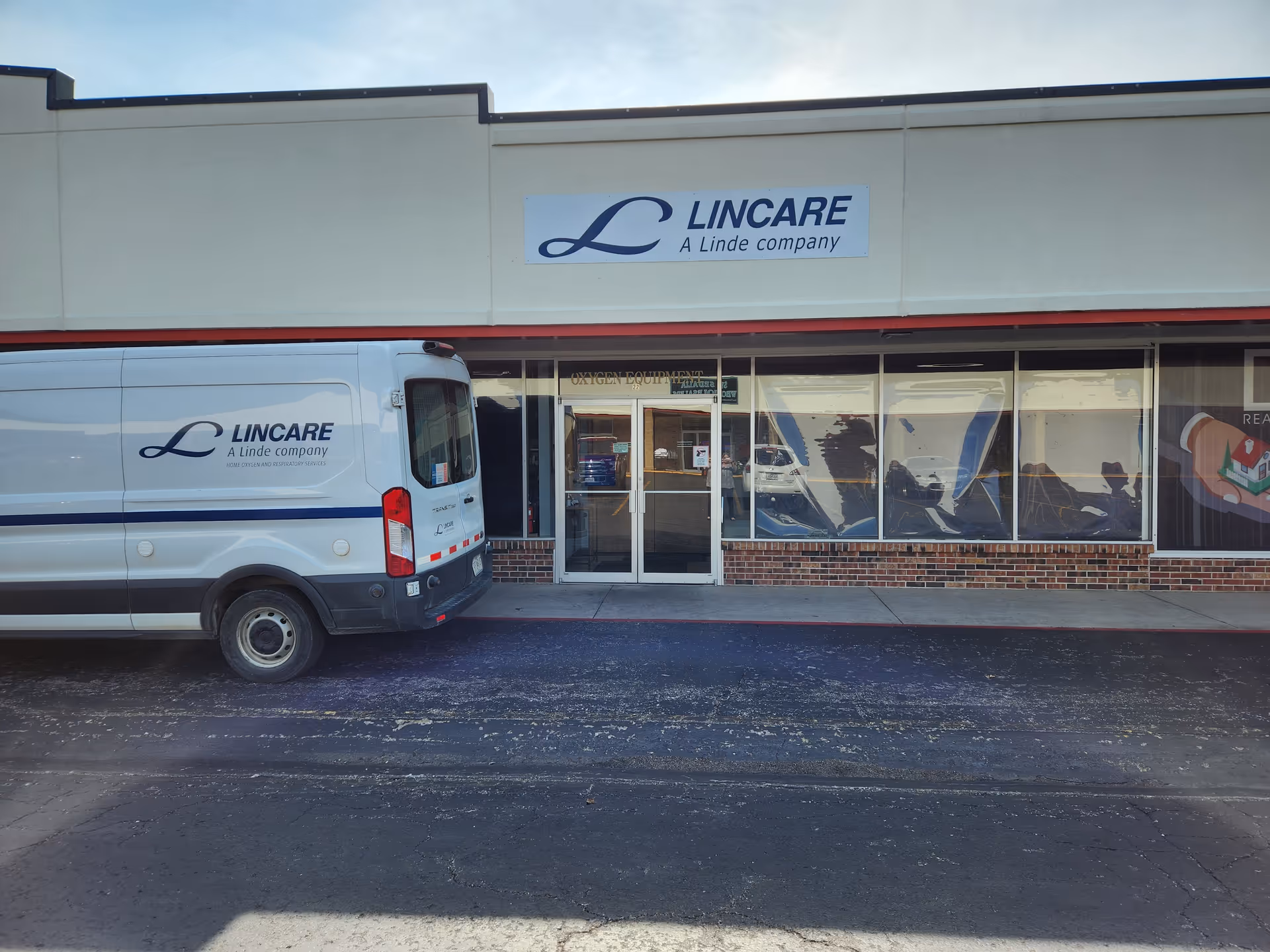 Exterior view of a LINCARE building front with a branded van parked outside.