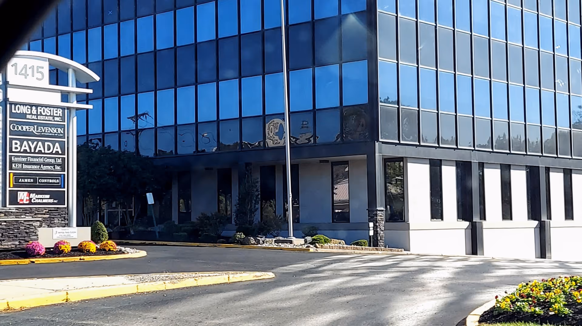 Modern glass-front building with BAYADA Assistive Care signage and landscaped entrance.