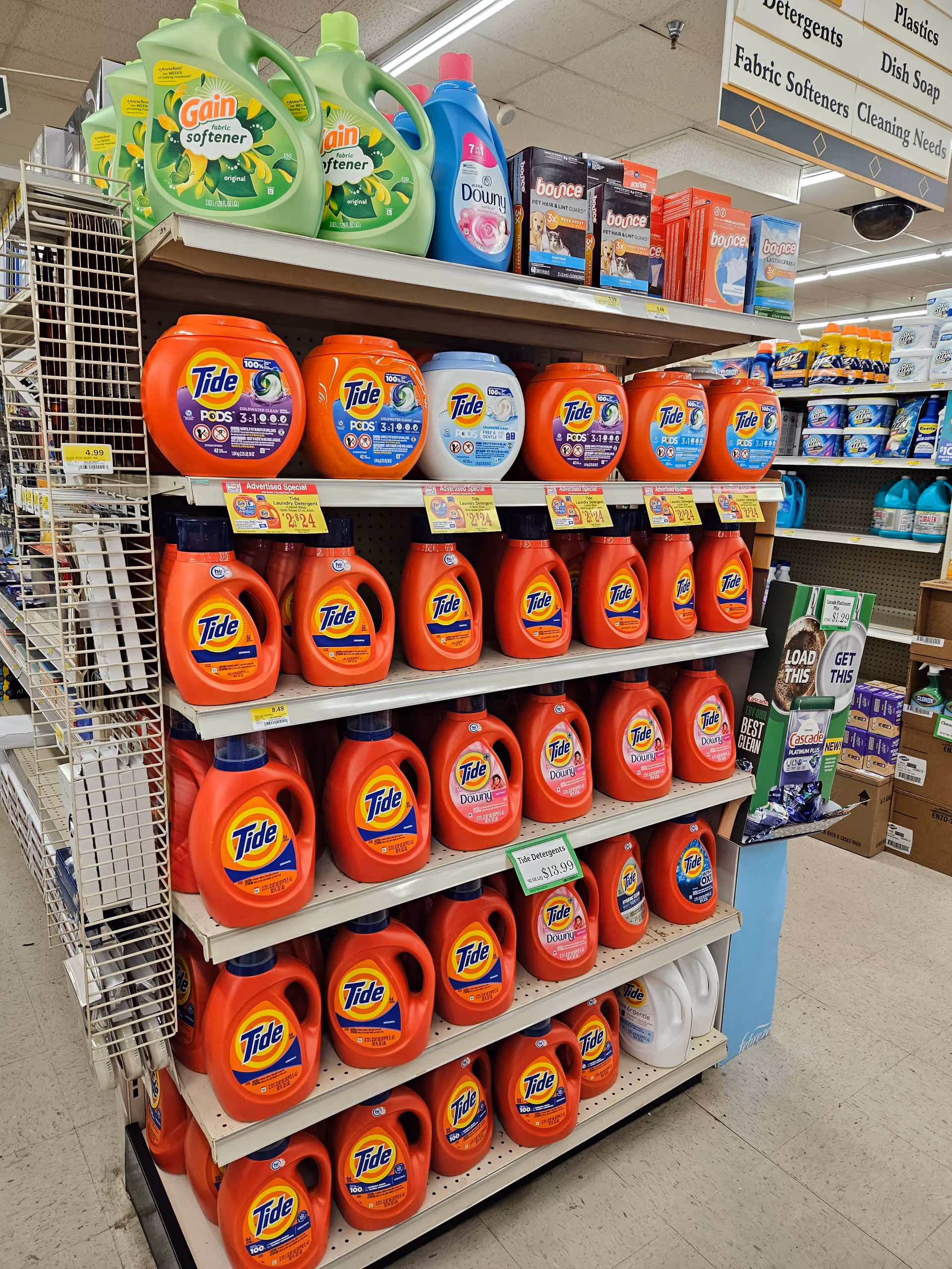 Aisle of Tide laundry detergents on shelves inside a Discount Drug Mart store.