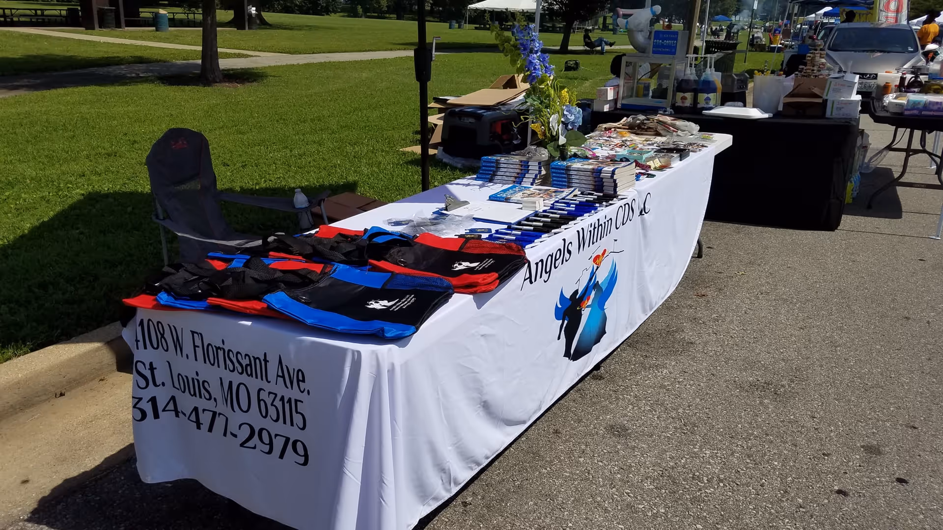 Outdoor booth with a long tablecloth and books for Angels Within CDS LLC.