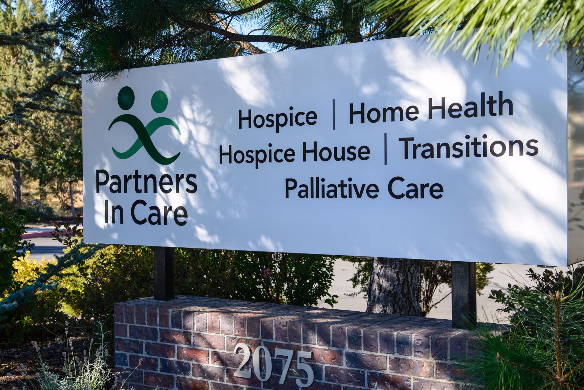 Outdoor sign for Partners In Care with hospice, home health, and palliative services.