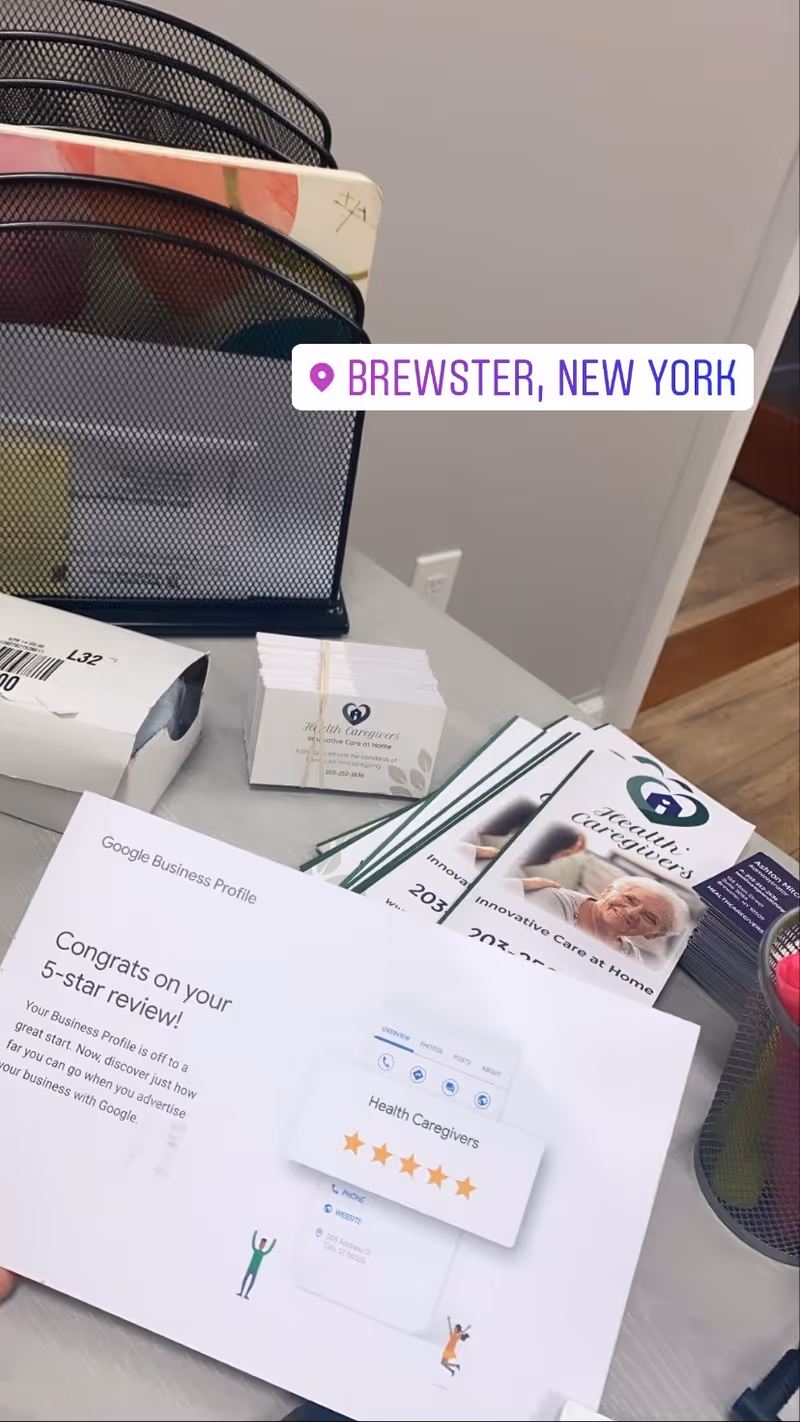 Office desk with brochures, business cards, and a Brewster, New York label.