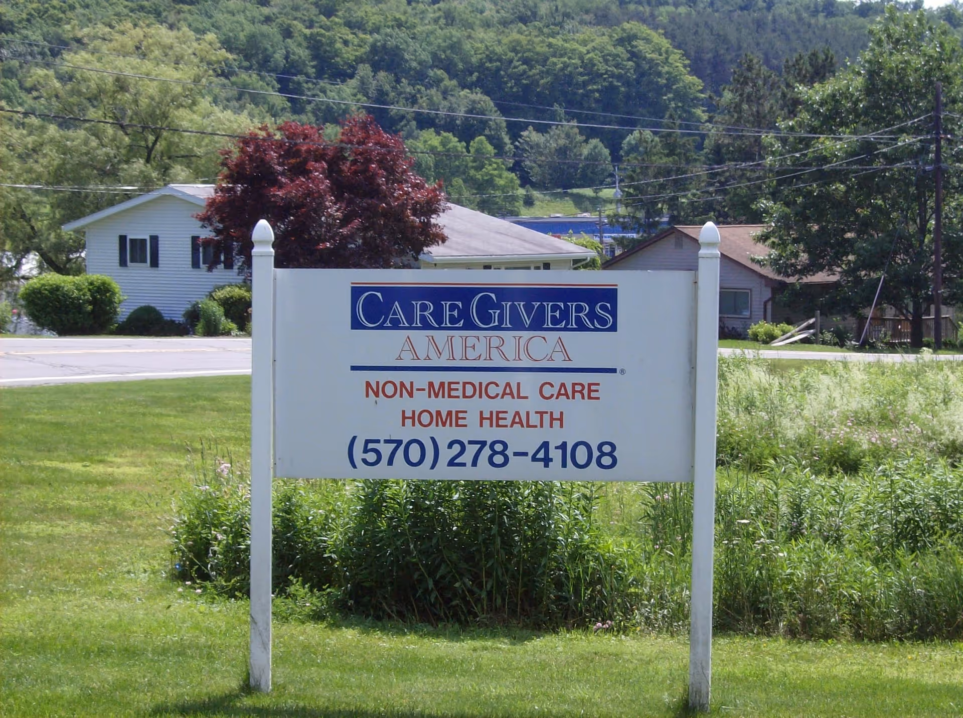 Outdoor view of CareGivers America sign on a grassy front yard.