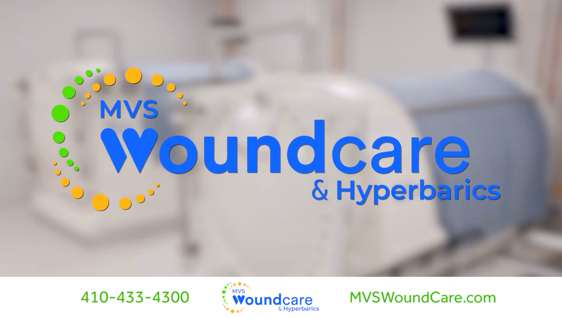 Interior clinical room featuring a large wound care hyperbaric chamber and logo.