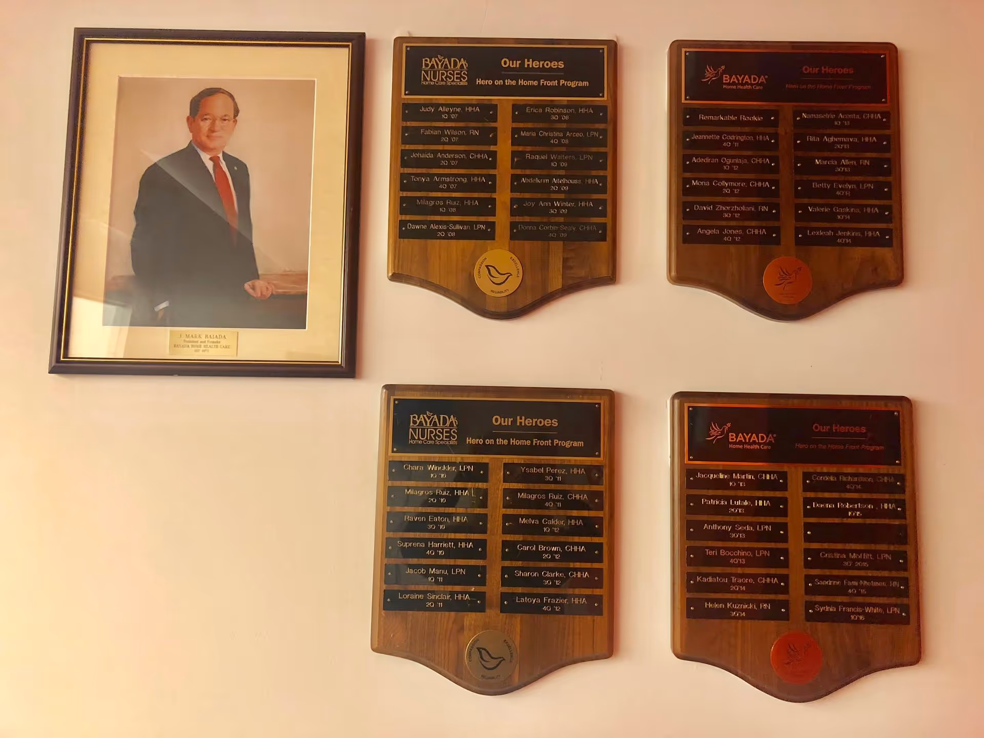 Interior wall featuring a framed portrait and four BAYADA Nurses honor plaques.