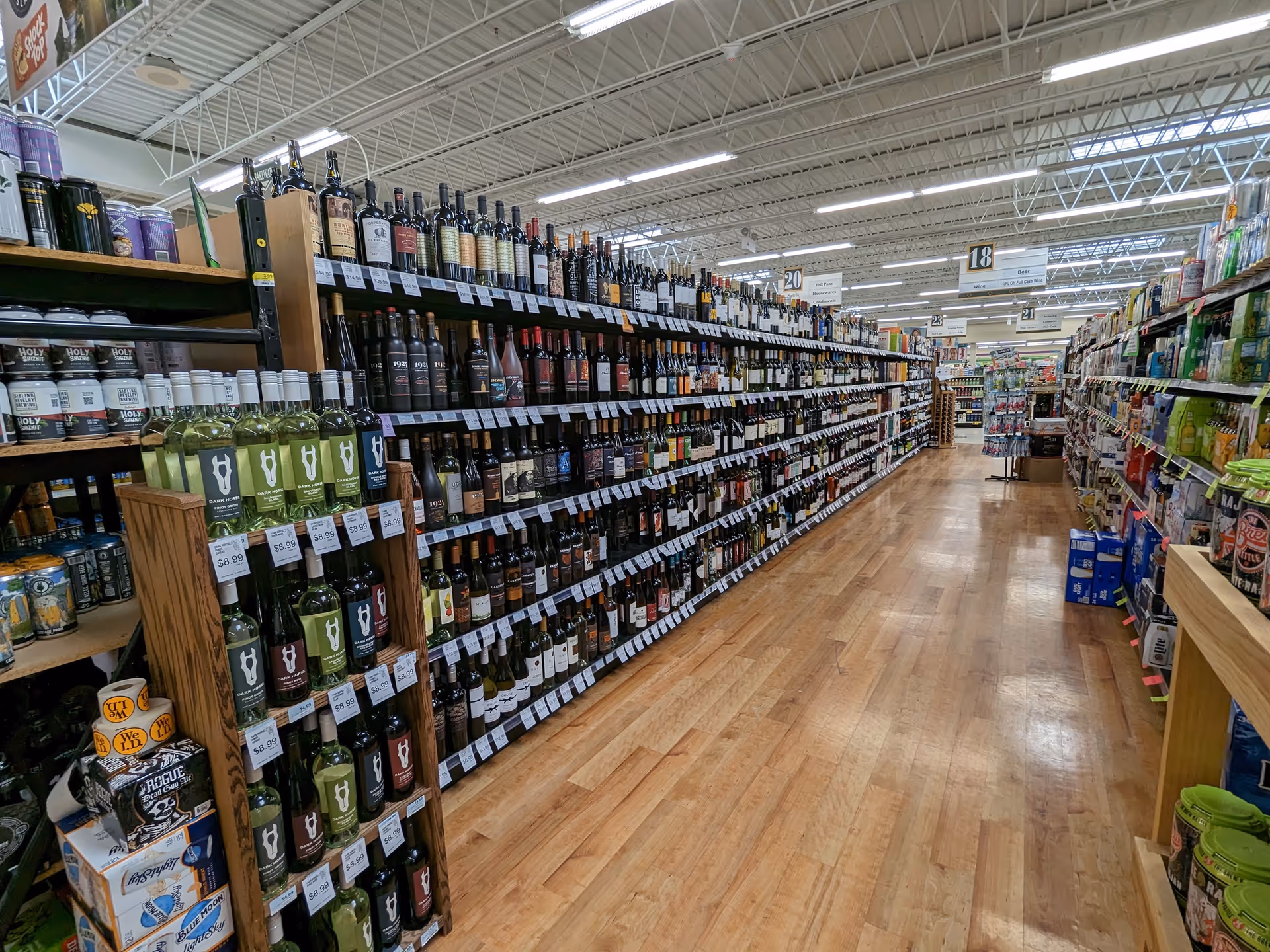 Interior of Discount Drug Mart showing aisle of bottled beverages on shelves.