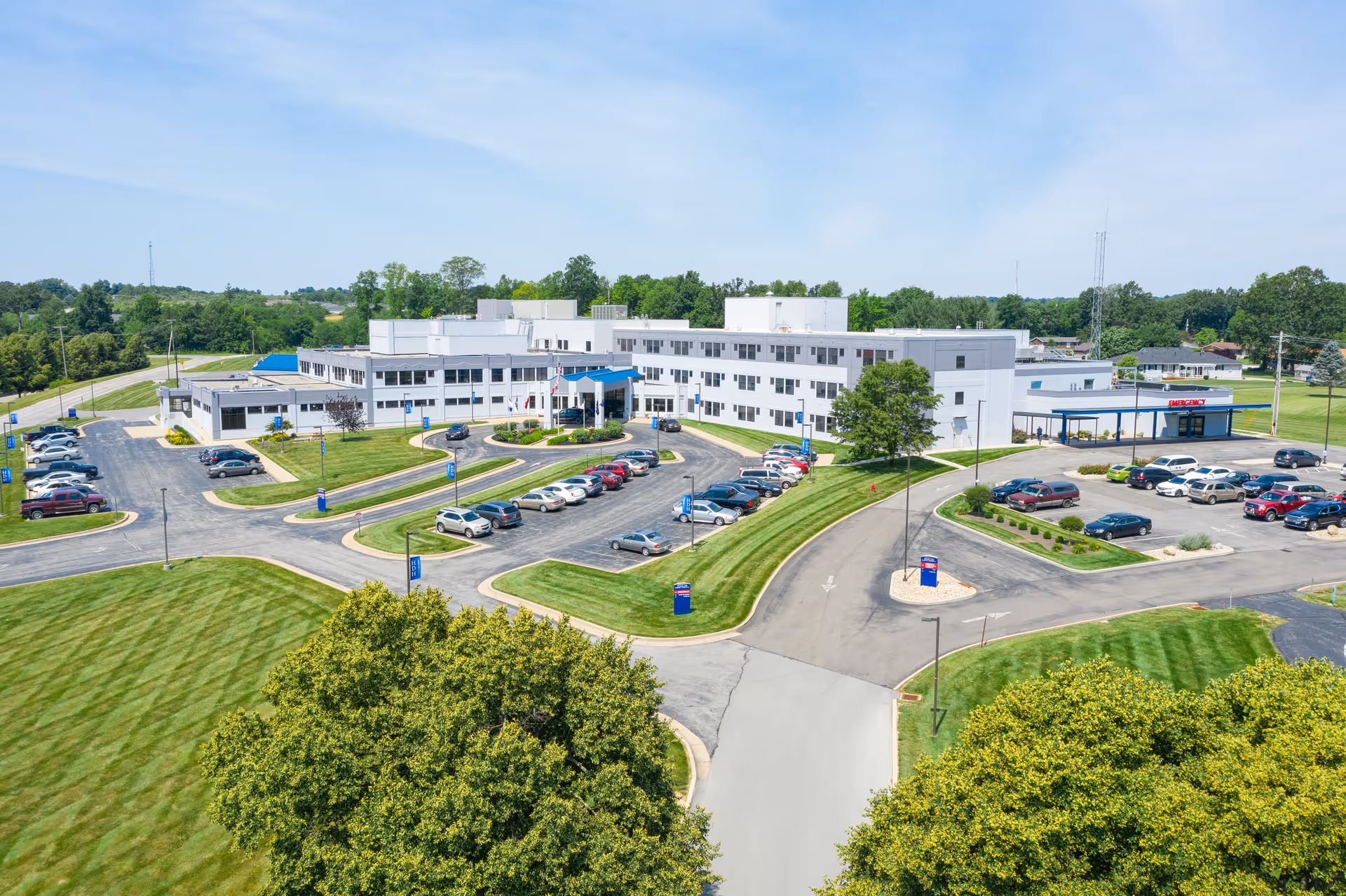 Aerial view of Highland District Hospital campus with parking and green landscaping.
