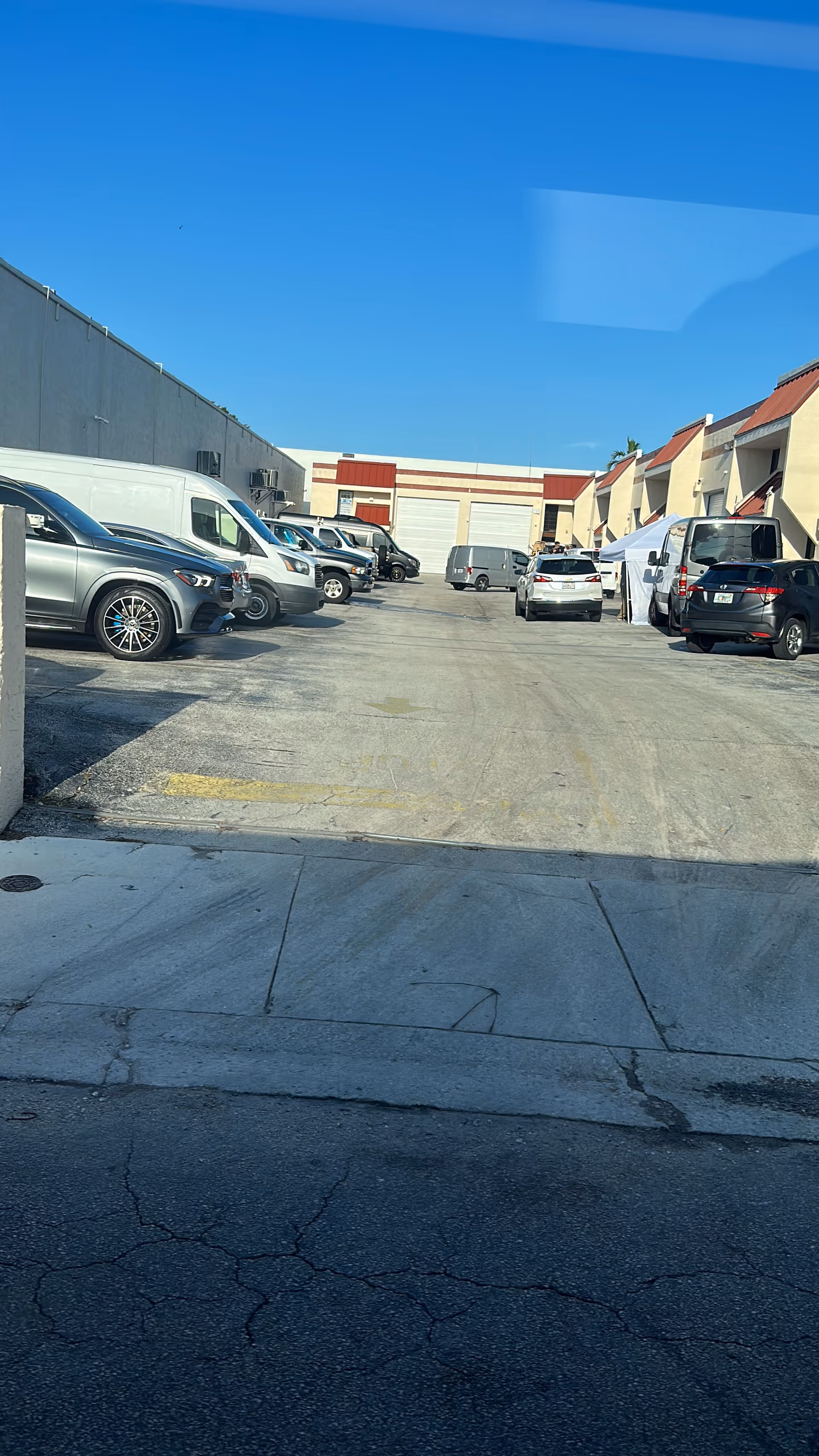 A parking lot outside a senior living facility with parked cars and row buildings.