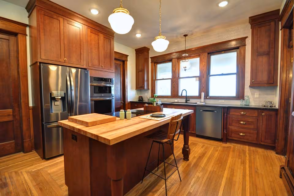 Spacious kitchen with an island, stainless appliances, and wooden cabinetry.