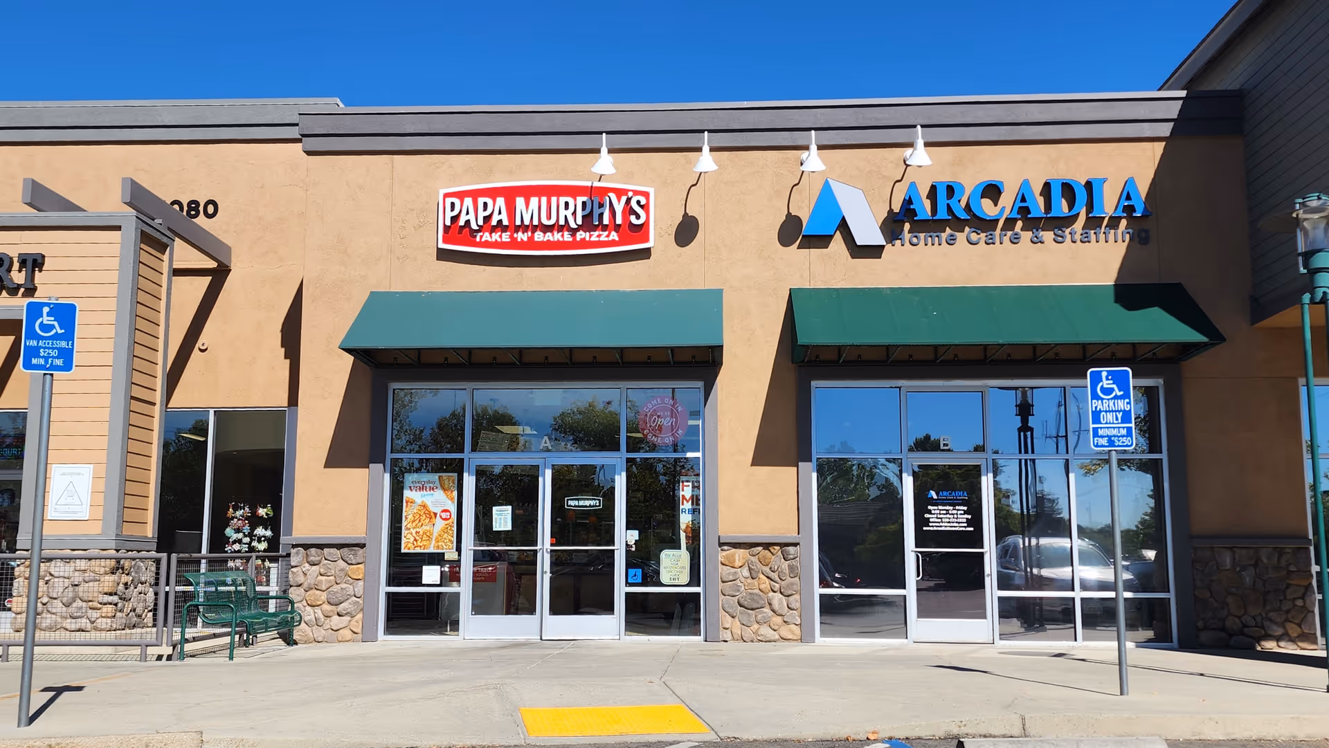 Exterior view of a shopping strip with Papa Murphy's and Arcadia Home Care signage.