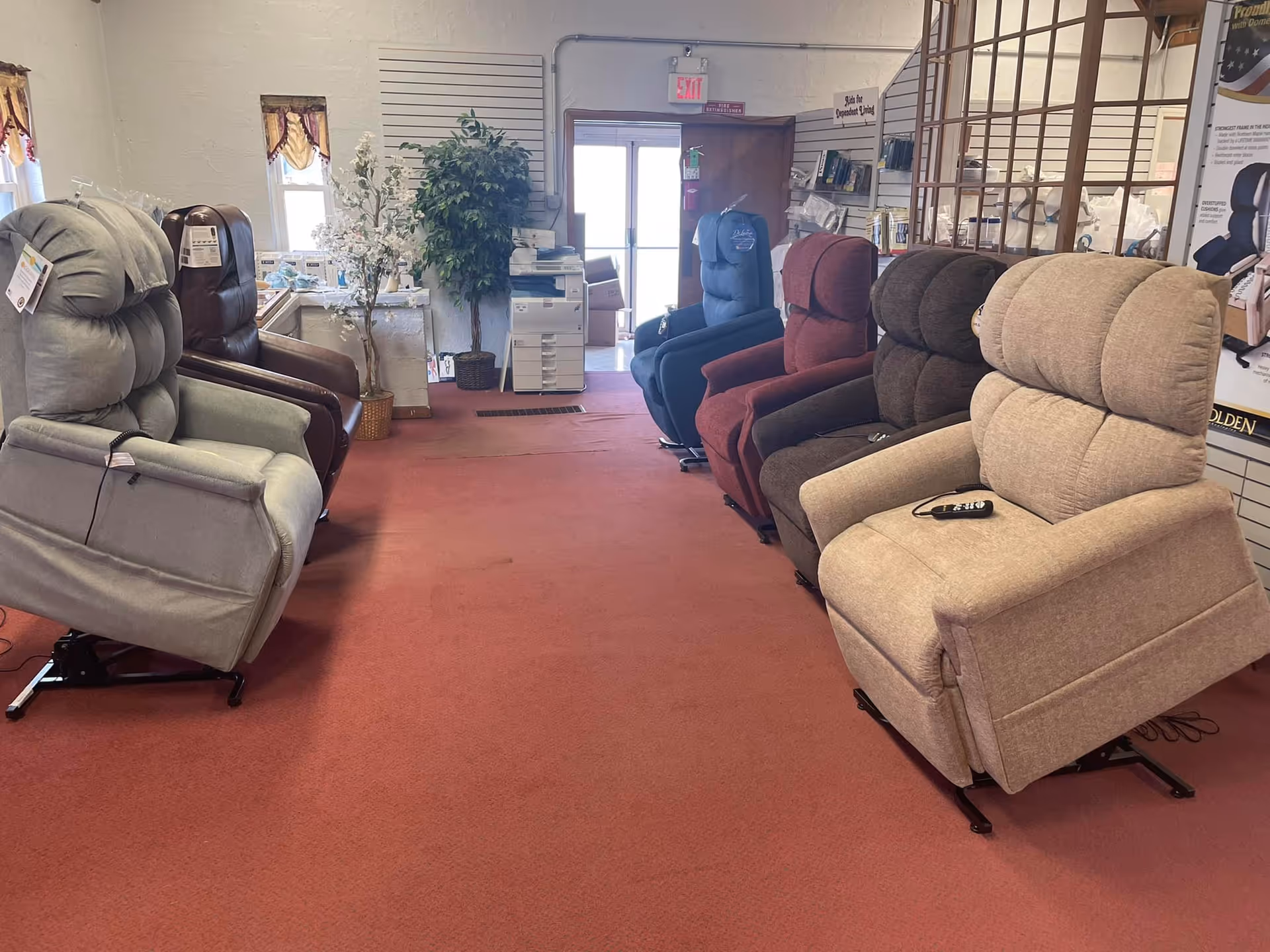 Row of plush lift chairs lined up inside Sobaks Home Medical, Inc. showroom.