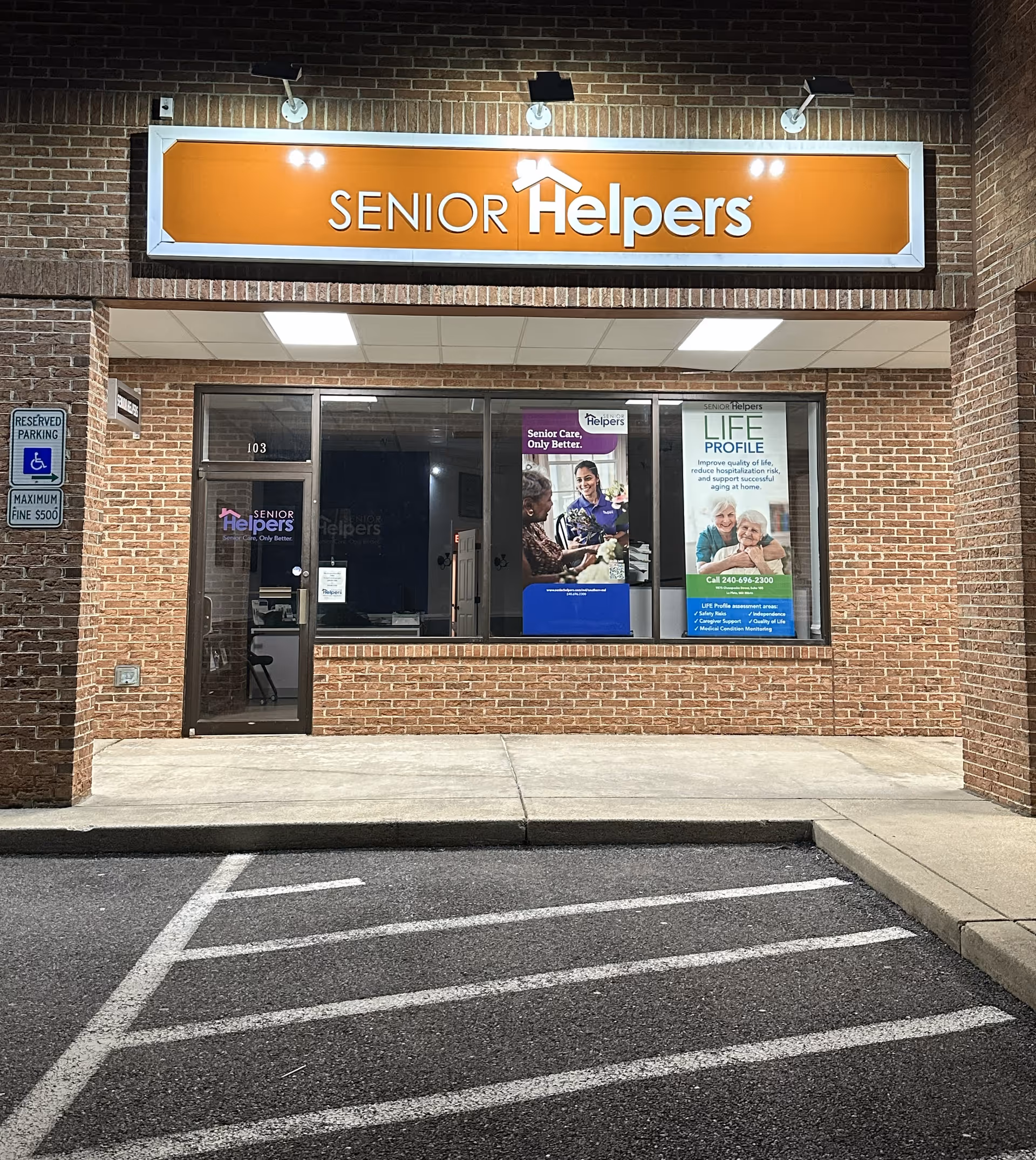 Exterior of Senior Helpers storefront with orange sign and brick facade