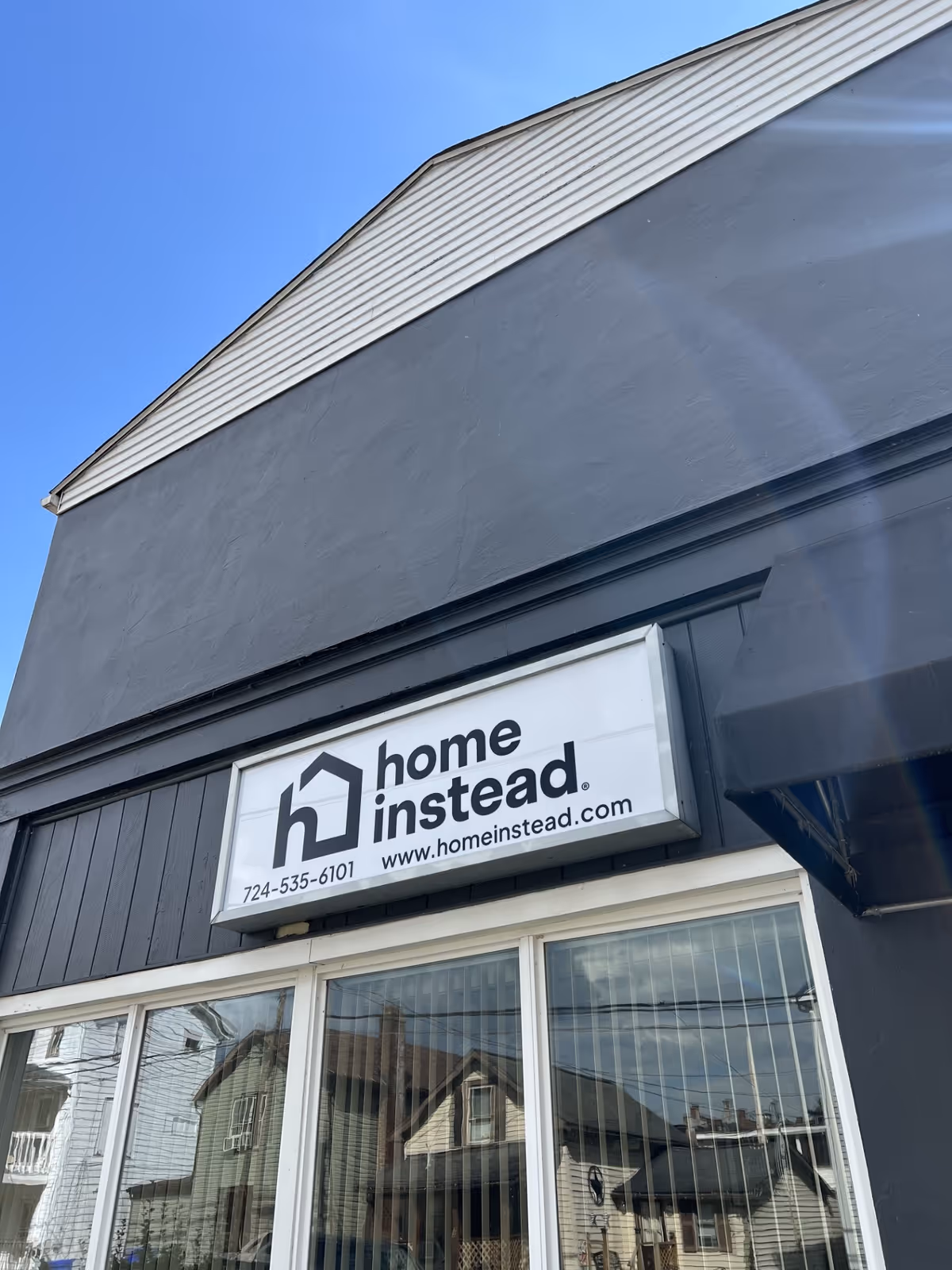 Exterior view of a building with a Home Instead sign on the front.