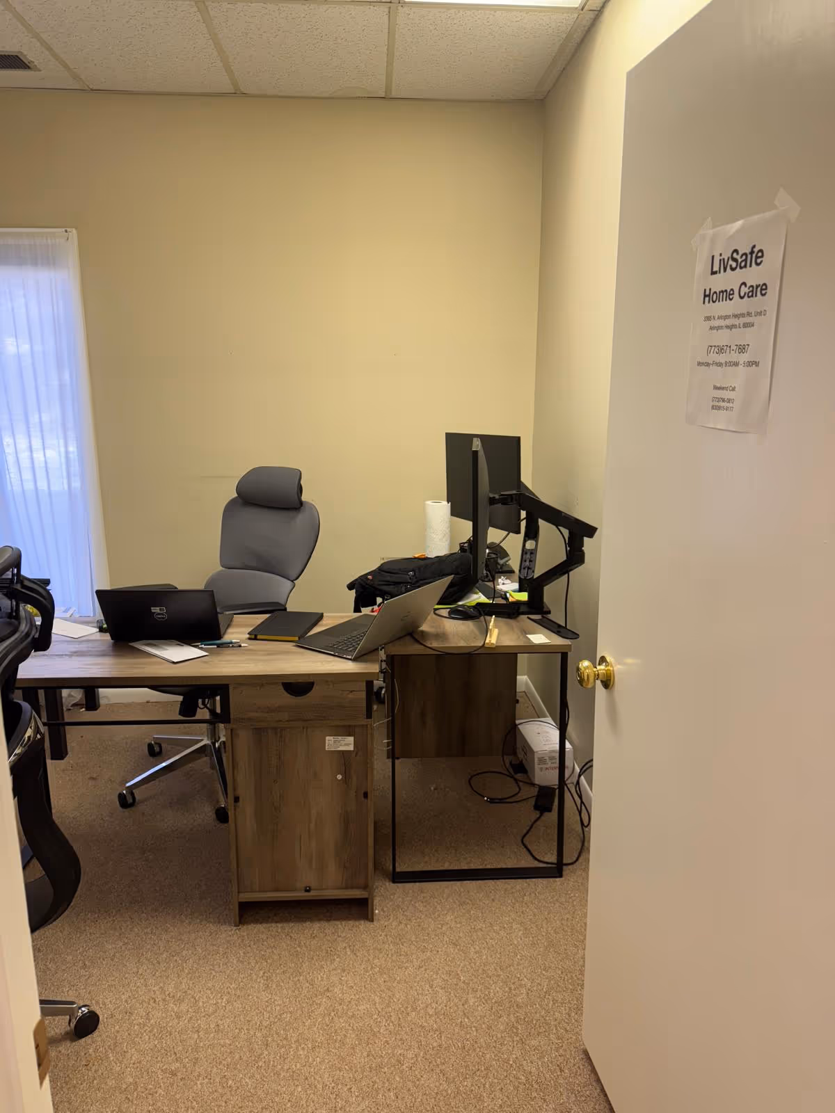 Office workspace inside LivSafe Home Care with desk, computers, and chairs.