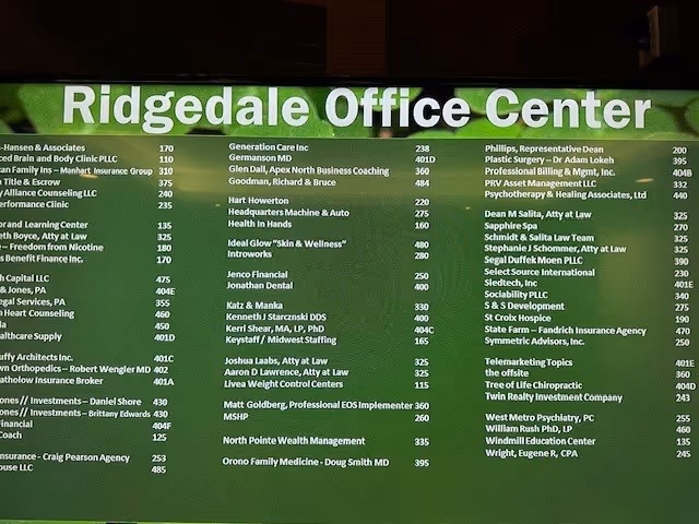 Large green directory sign lists tenants at Ridgedale Office Center.
