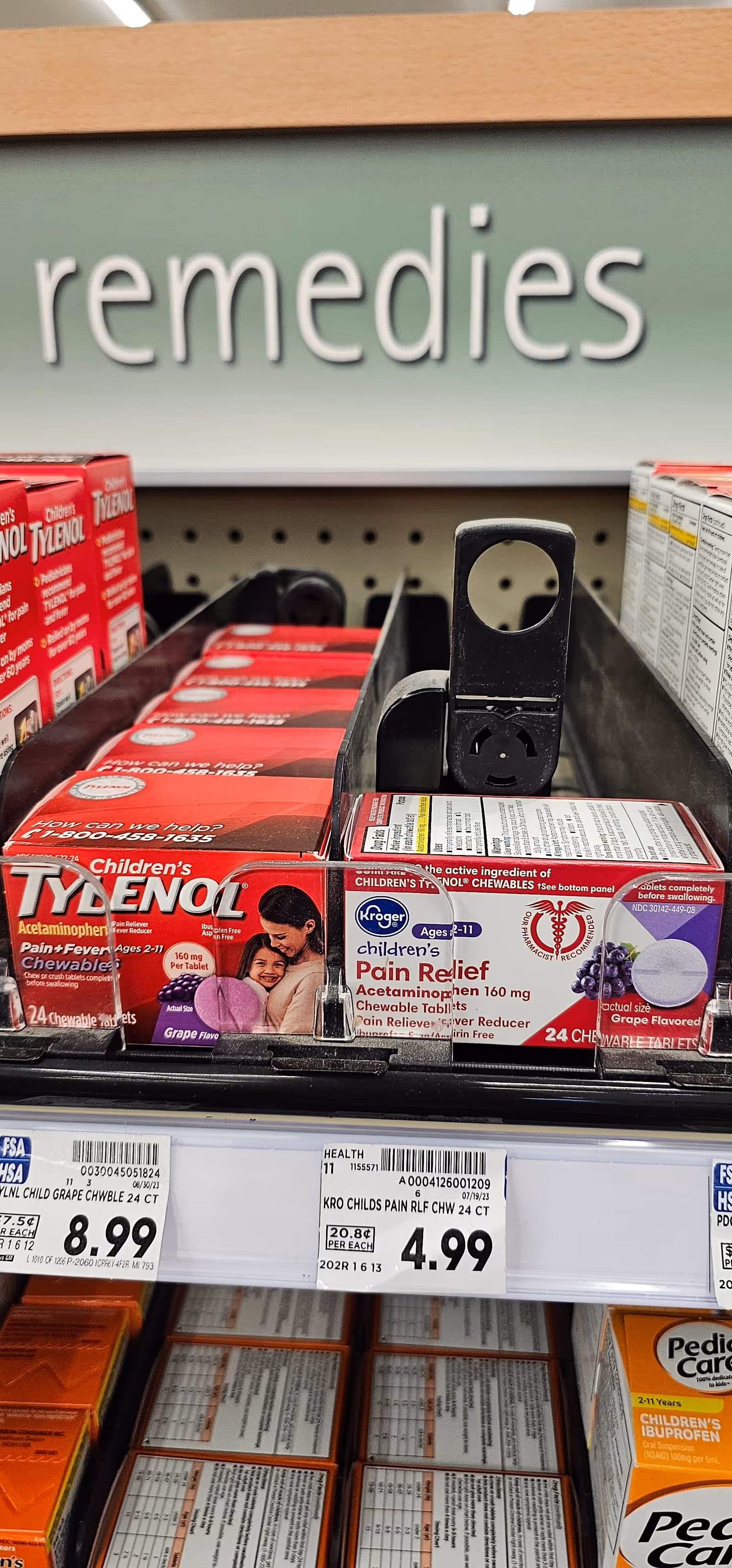 Inside Kroger Pharmacy, a shelf displays Tylenol and Children's Pain Relief boxes.