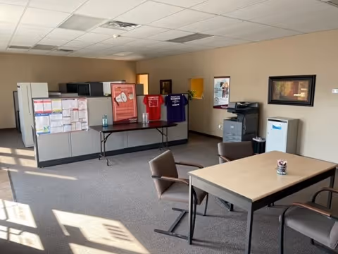 Bright interior common area with a reception counter, file boxes, and seating.