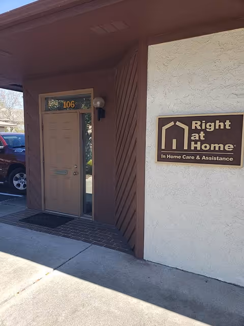 Exterior view of Right at Home entrance with door and business sign.