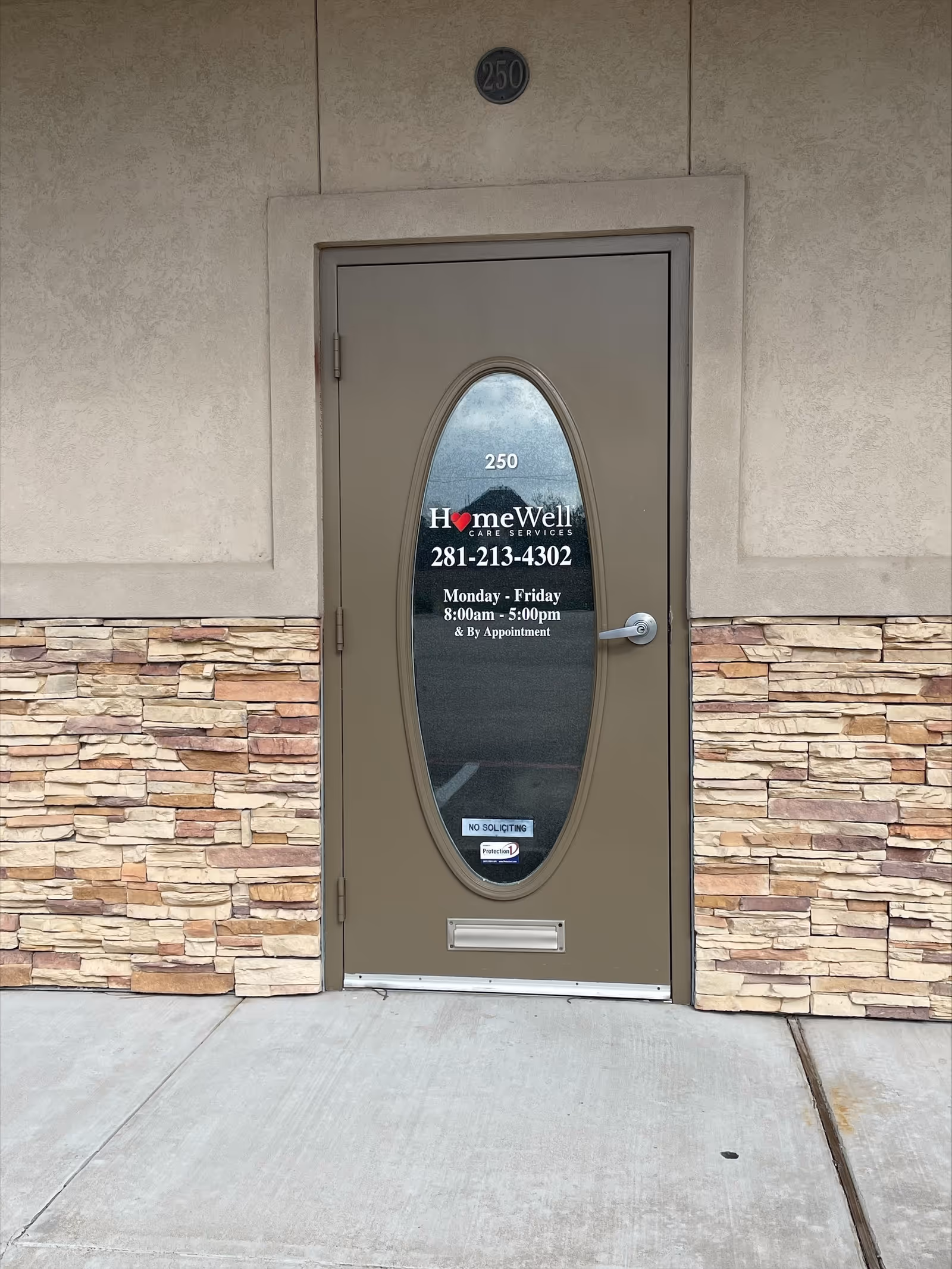 Front exterior door with oval window and HomeWell Care Services signage