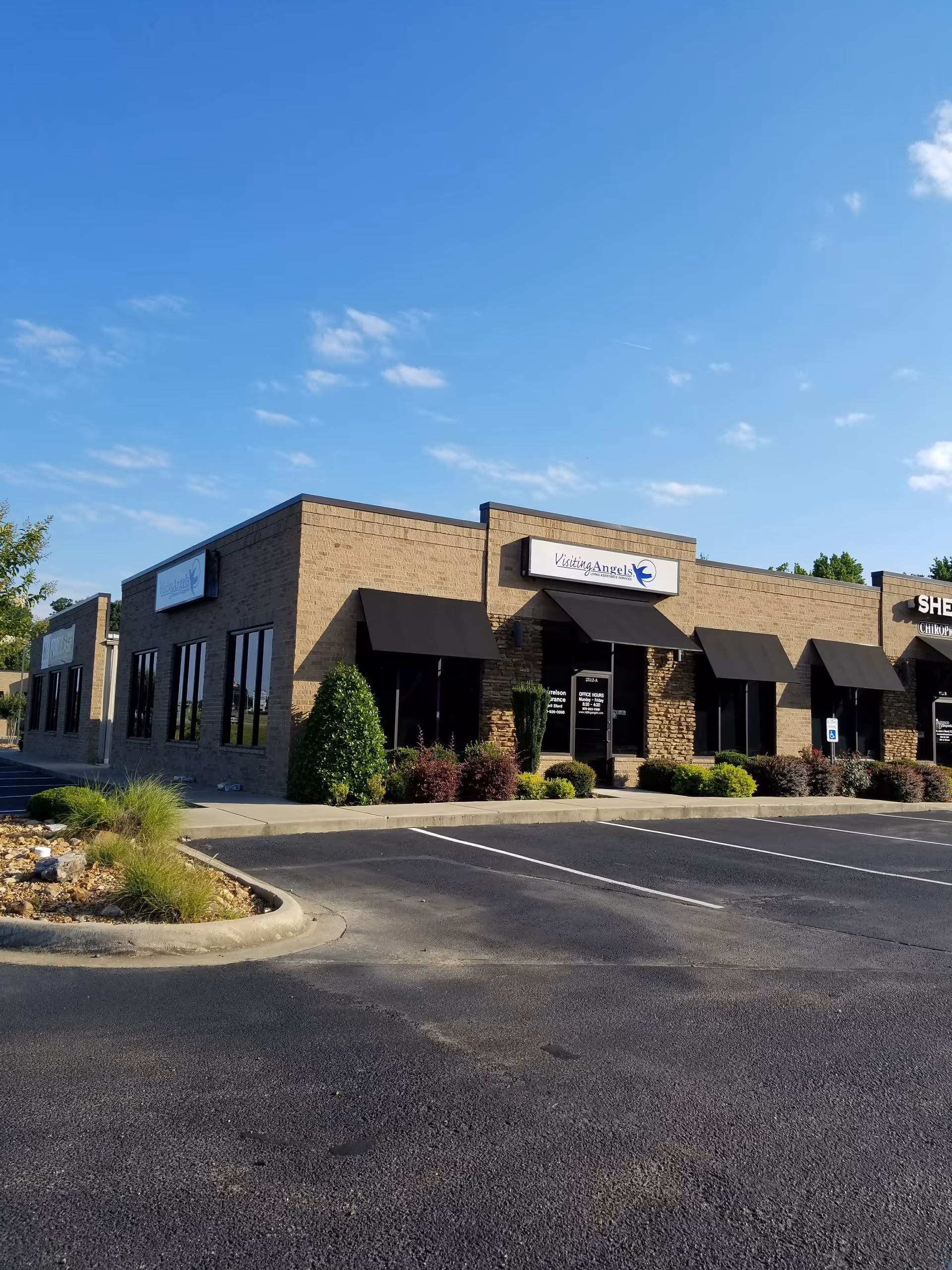 Exterior view of a Visiting Angels Senior Home Care building with a parking lot.