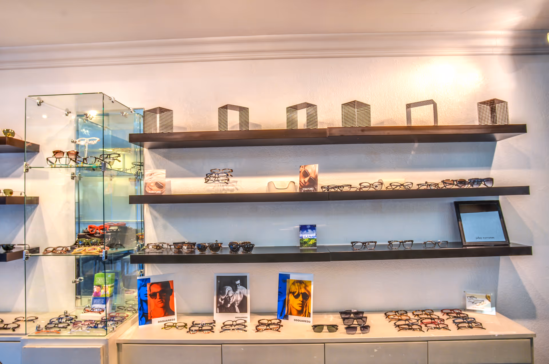 Interior optometry showroom with shelves displaying eyeglasses and sunglasses.