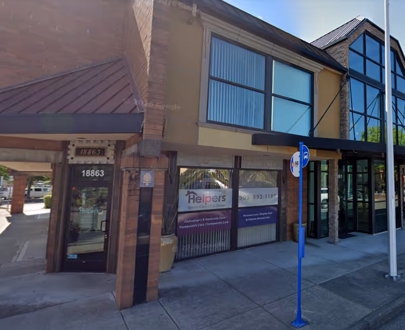 Exterior view of a Senior Helpers storefront with brick facade and large windows.