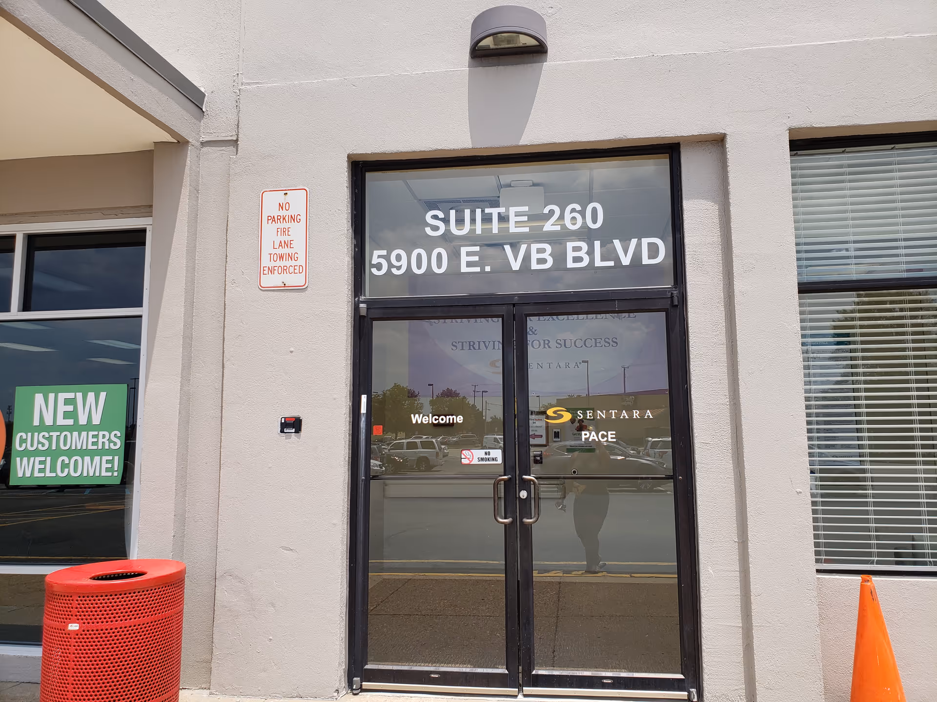 Exterior entrance of Sentara PACE building with glass doors and suite 260