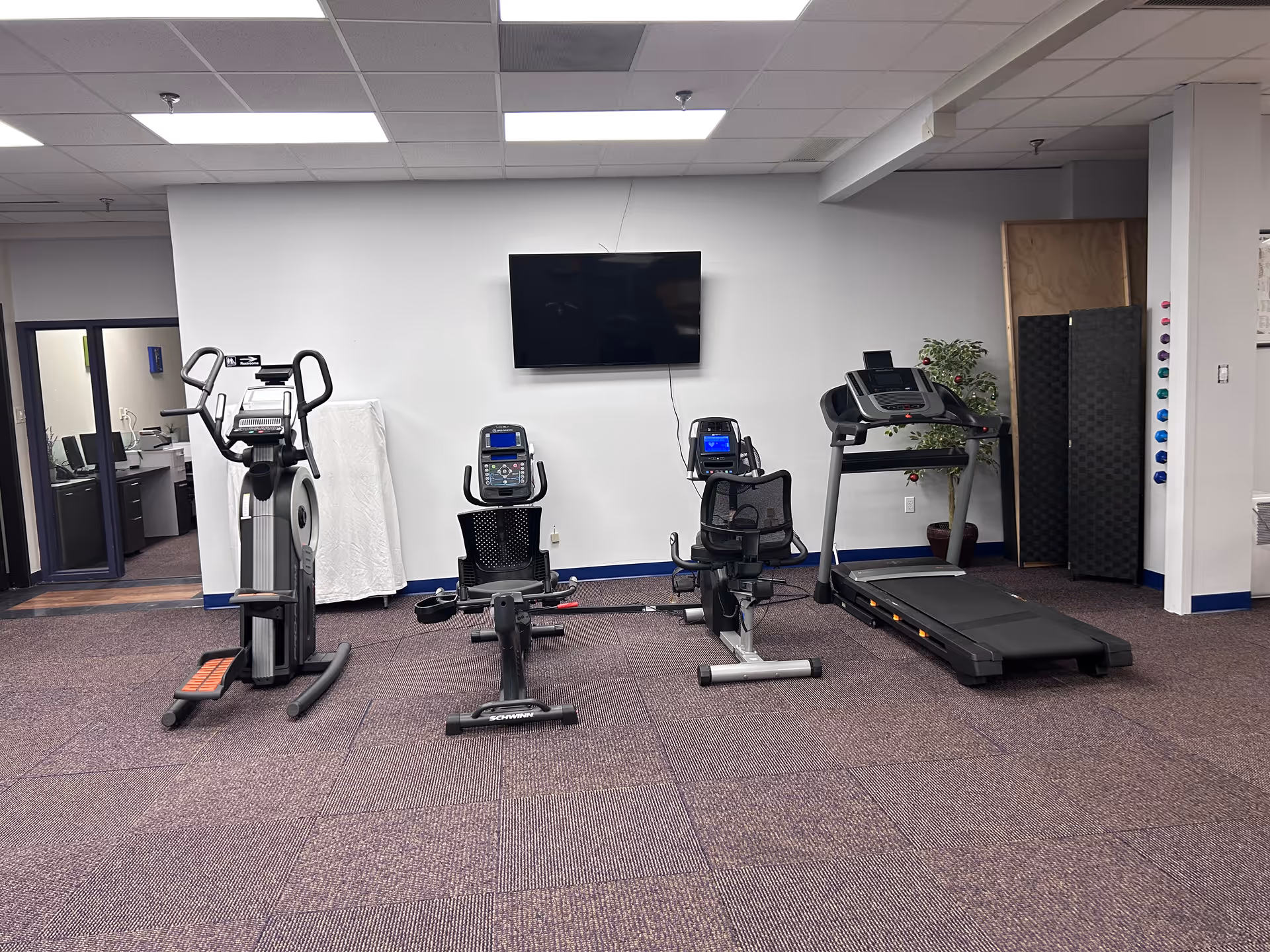 Fitness room in Apex Physical Therapy Merrillville with multiple exercise machines.