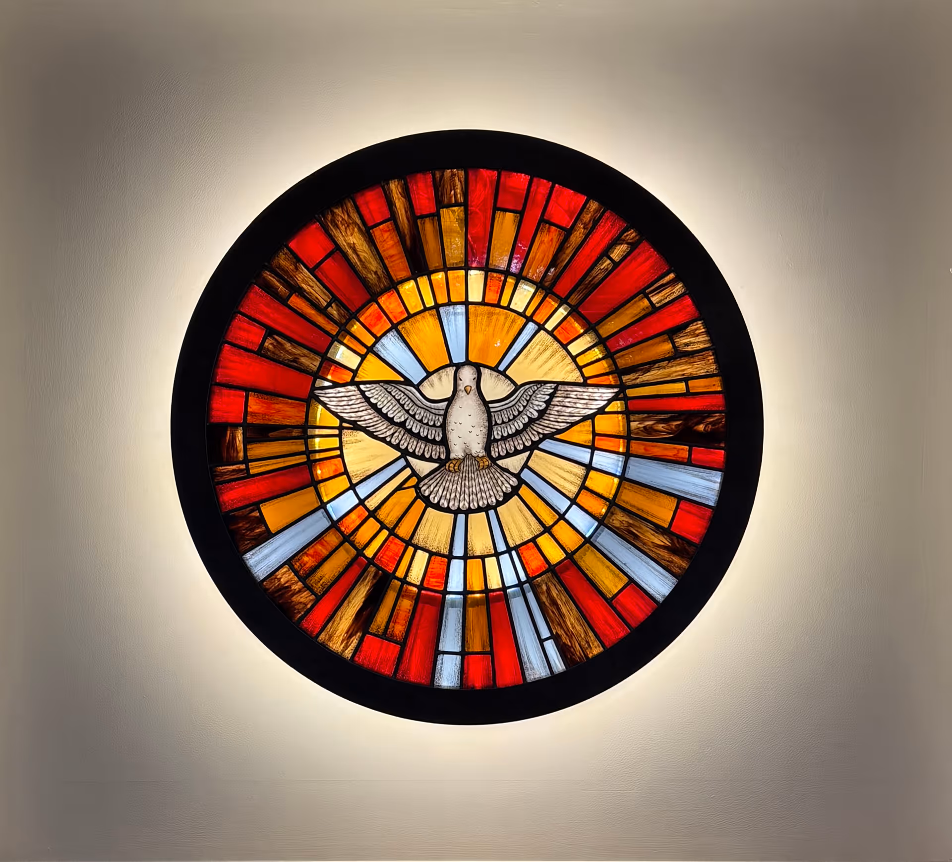 Circular stained-glass artwork featuring a dove, mounted on a wall.