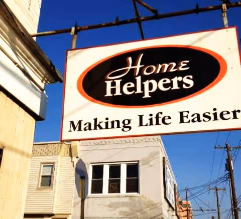 Exterior view of a building with a hanging sign reading Home Helpers: Making Life Easier.
