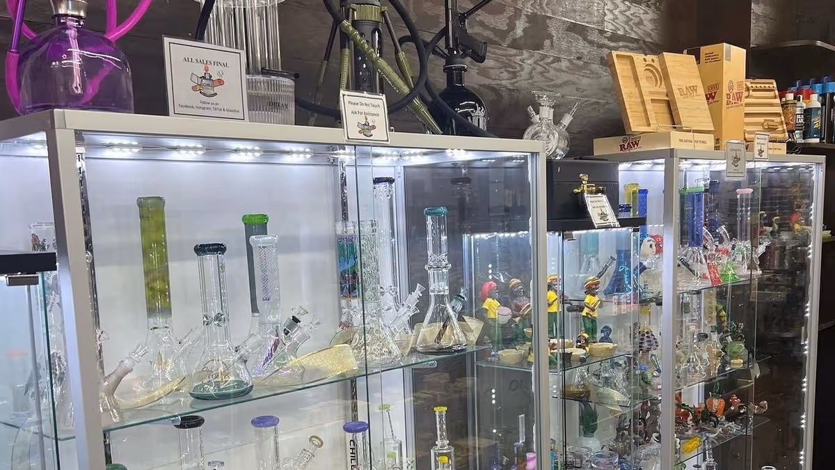 Glass display cases filled with colorful bongs and smoking accessories in a shop