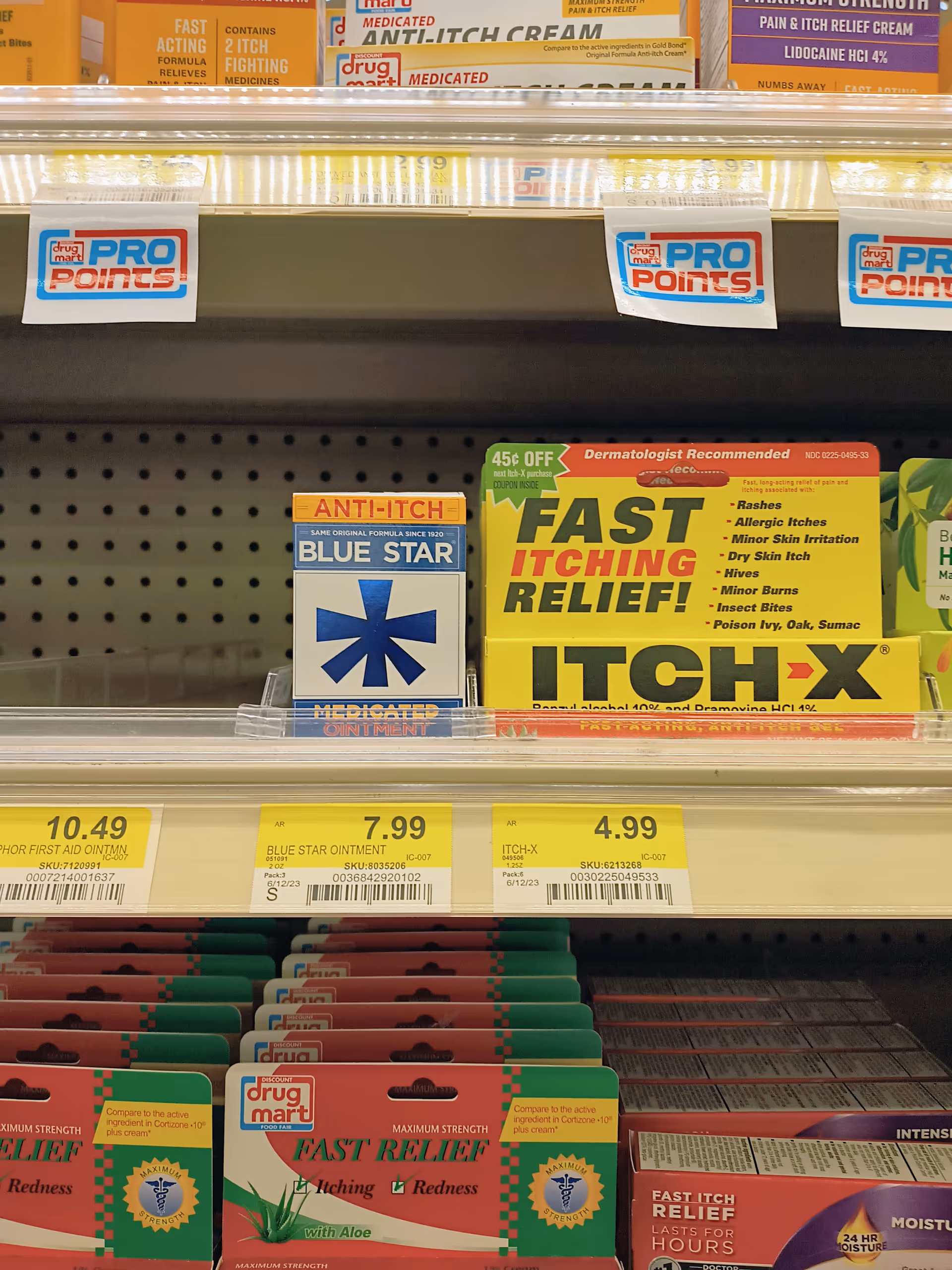 Pharmacy shelf with anti-itch ointment boxes and fast-relief topical products on display in Discount Drug Mart.