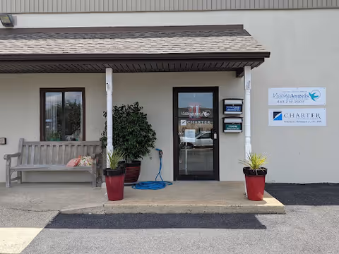 Exterior view of Visiting Angels Senior Home Care entrance with bench and planters.