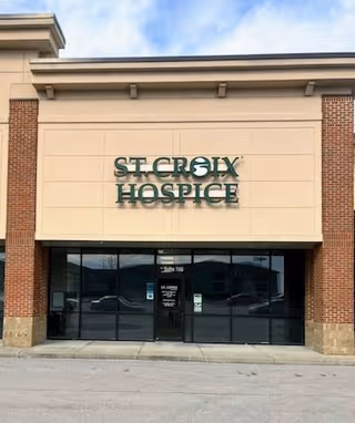 Front exterior of St. Croix Hospice building with glass doors.