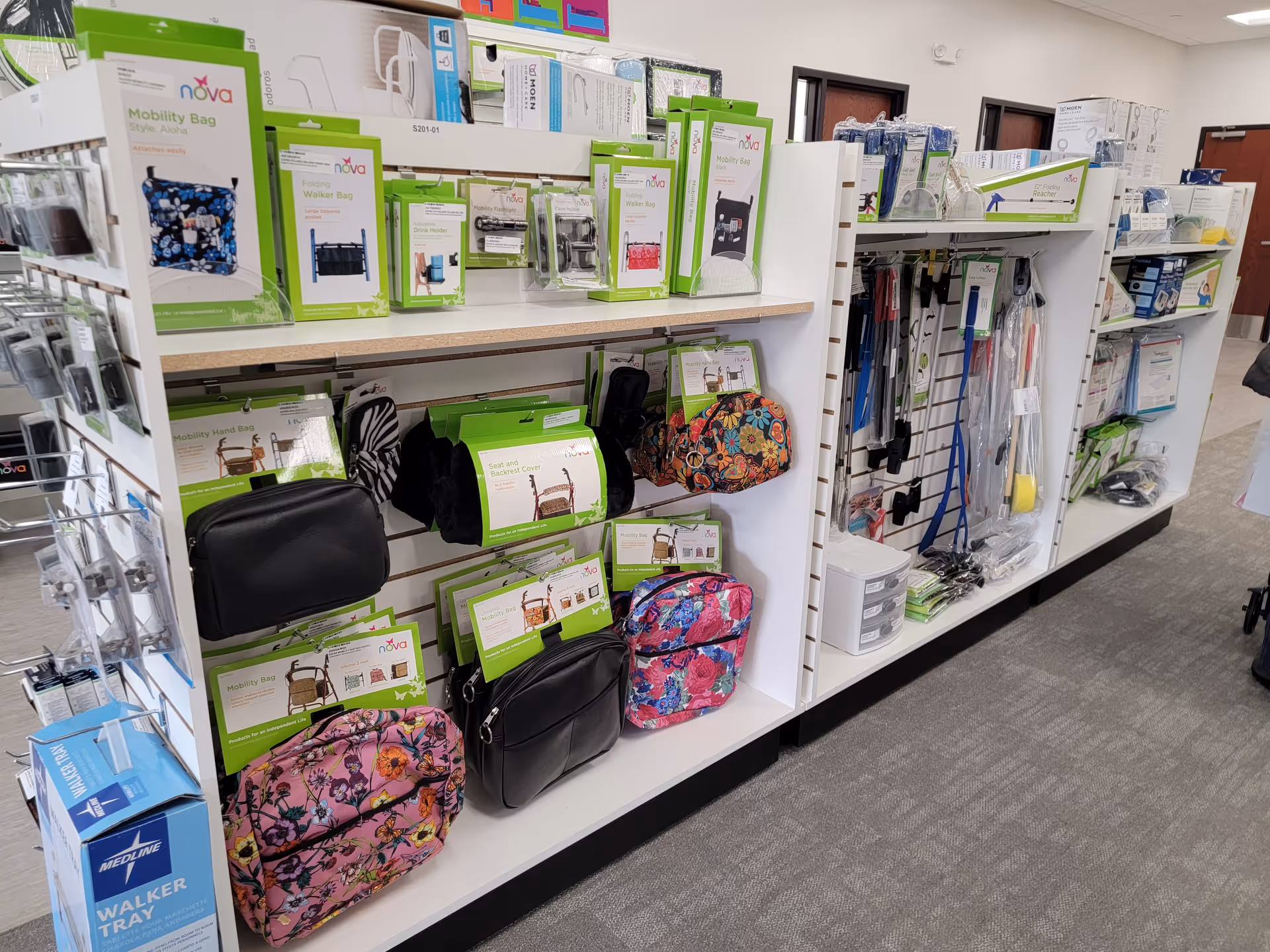 An interior aisle with shelves displaying mobility aids, bags, and medical supplies.