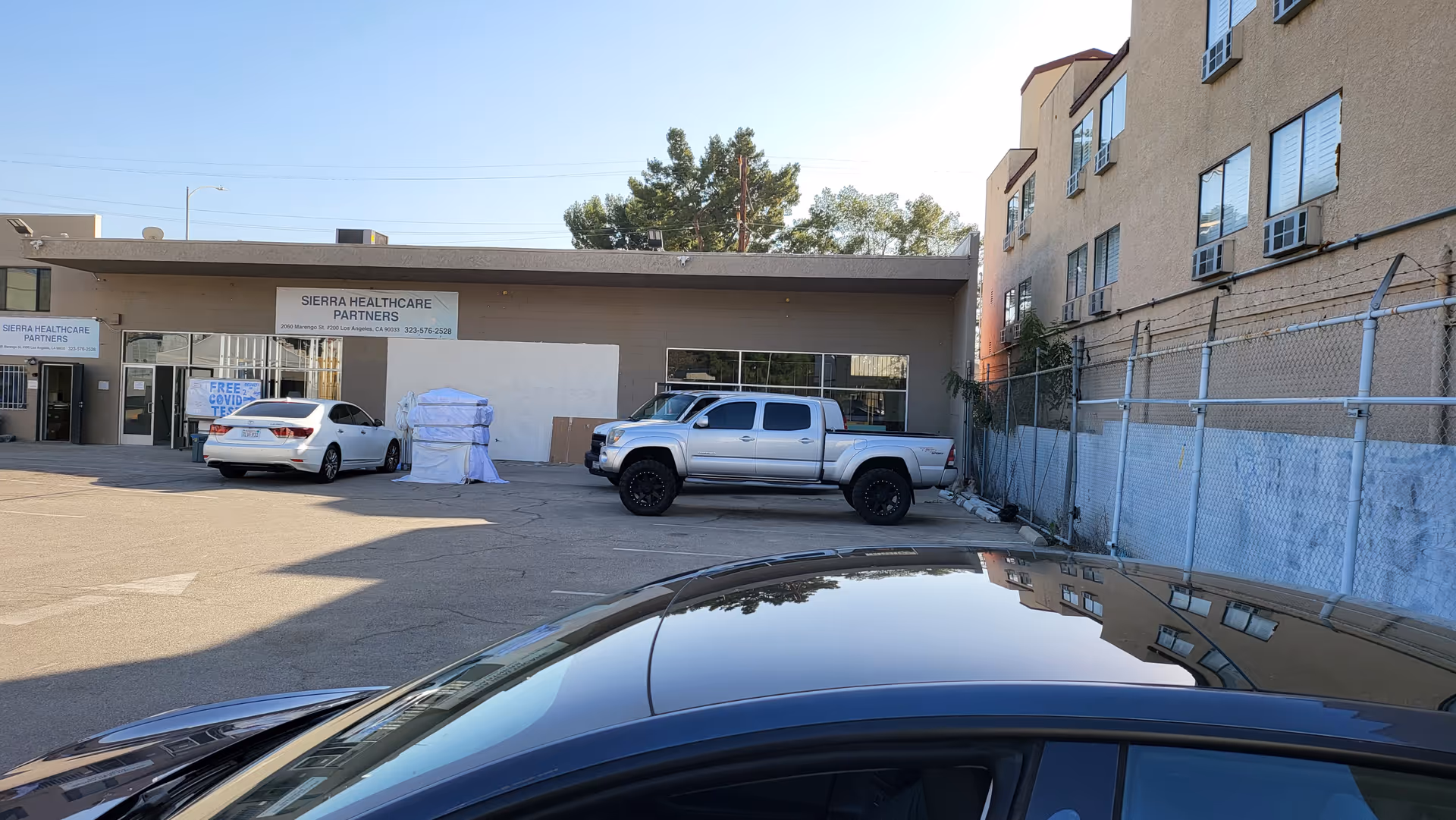 Front view of Sierra Healthcare Partners building with parked cars in the lot