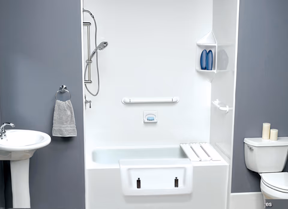 Accessible bathroom with bathtub, shower, sink, and toilet in a modern facility.