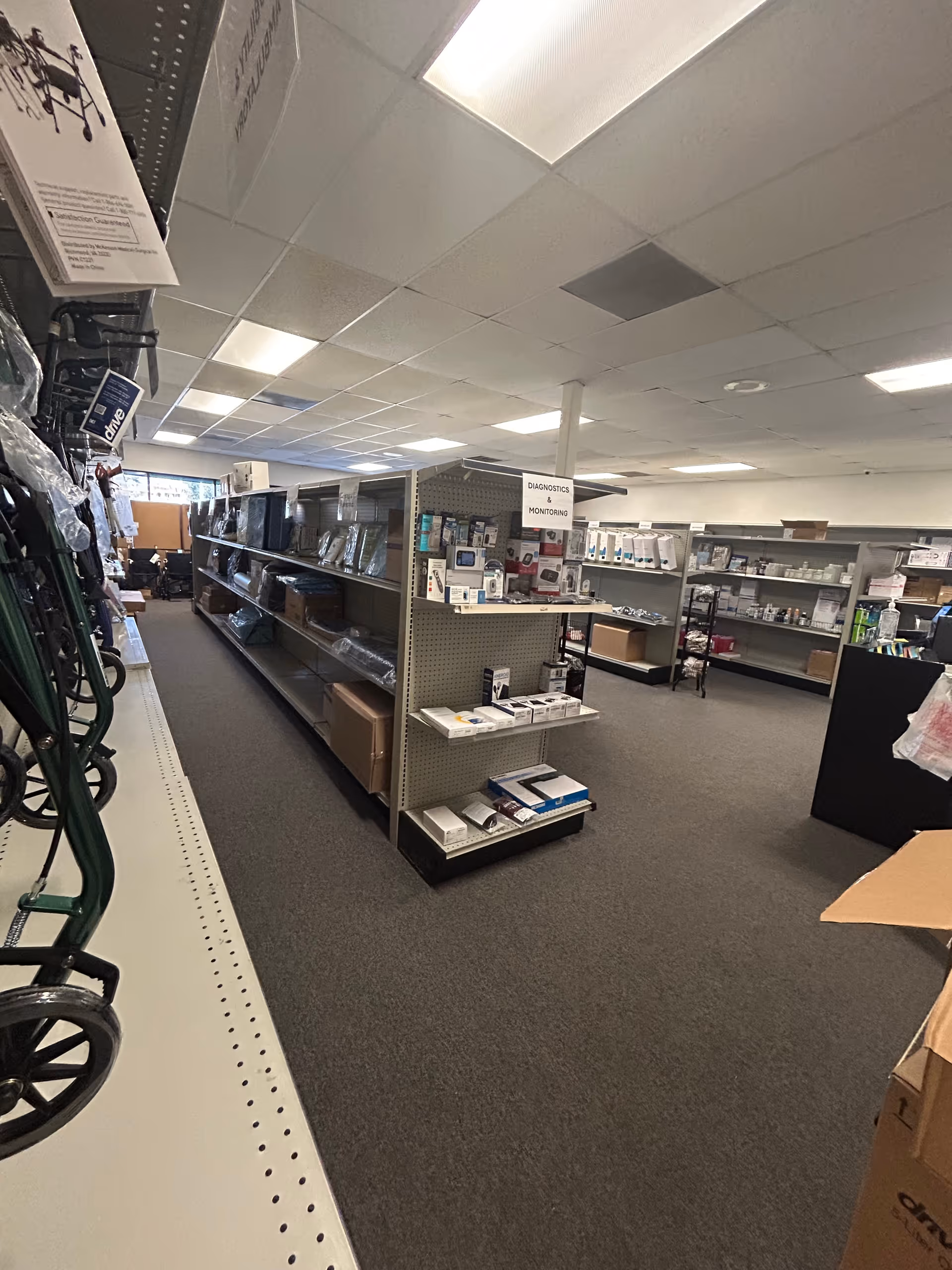 Interior view of a medical supply aisle with shelves and equipment in a facility