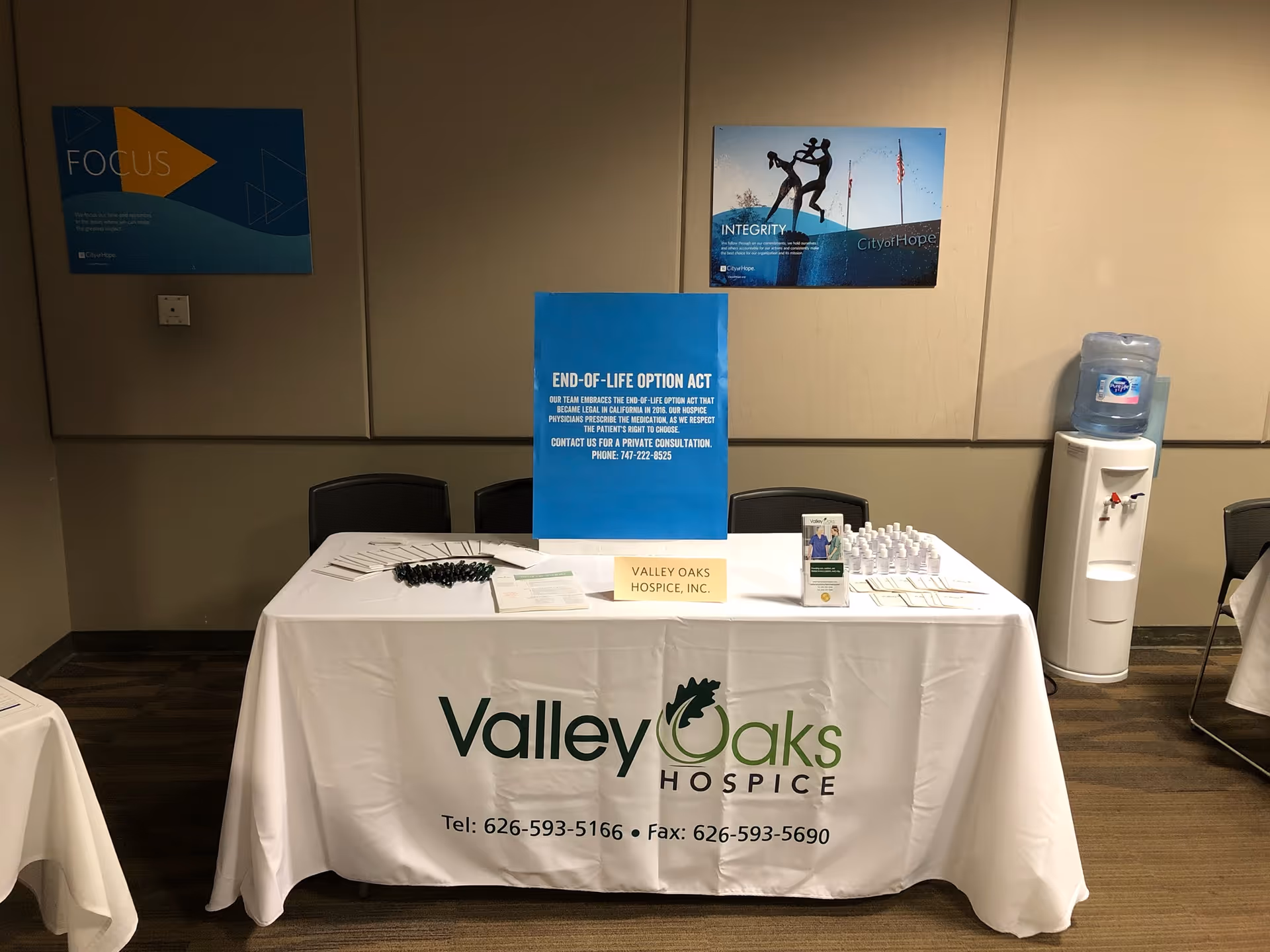 Indoor event table with Valley Oaks Hospice branding and brochures.